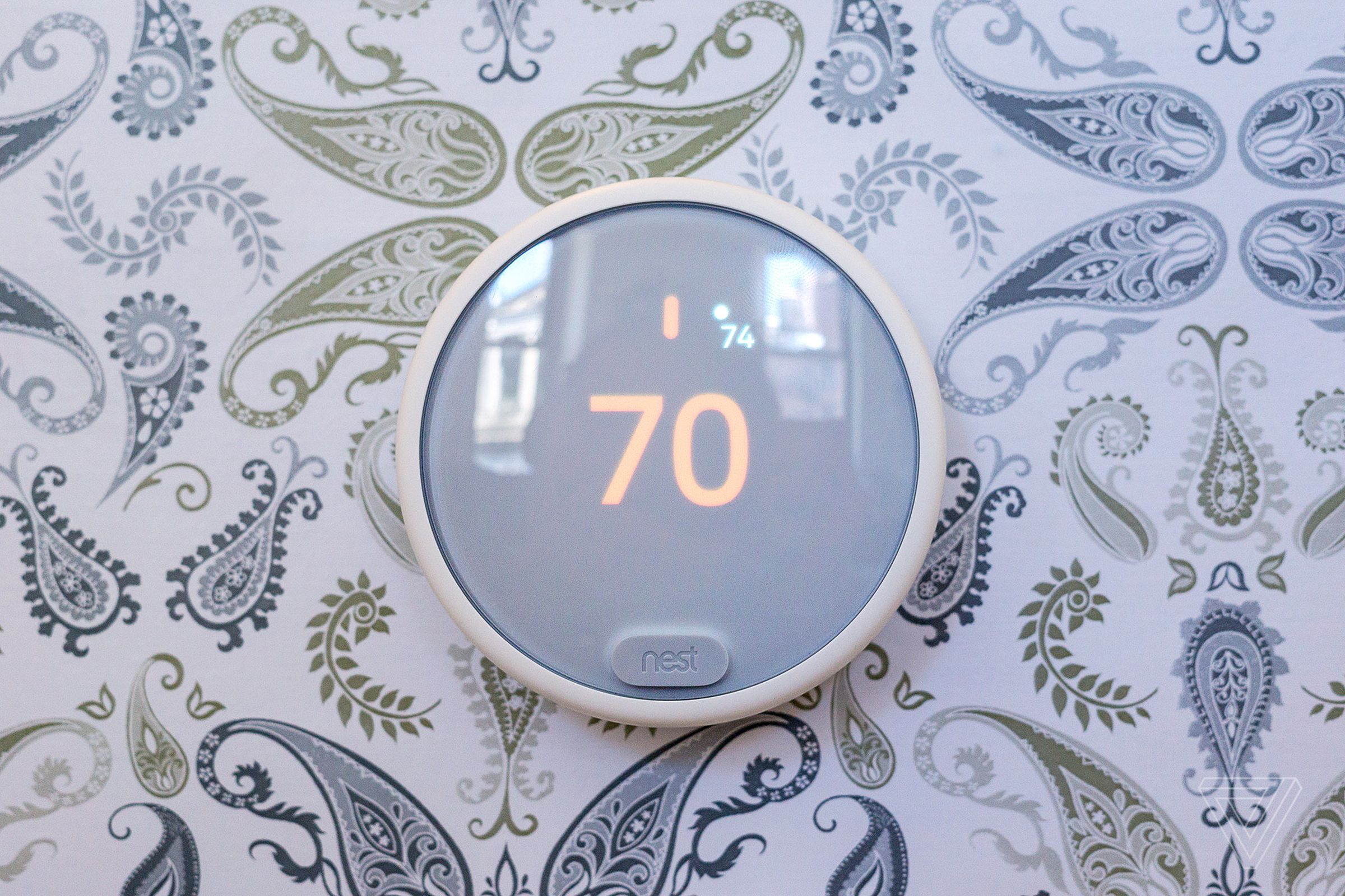 Nest E smart thermostat on wall with paisley wallpaper