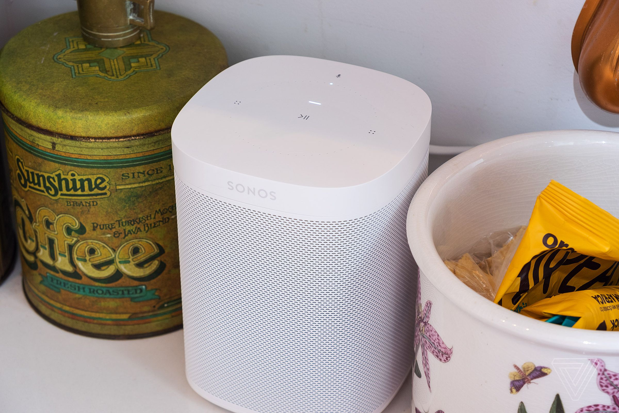 A photo of the Sonos One speaker on a kitchen counter.