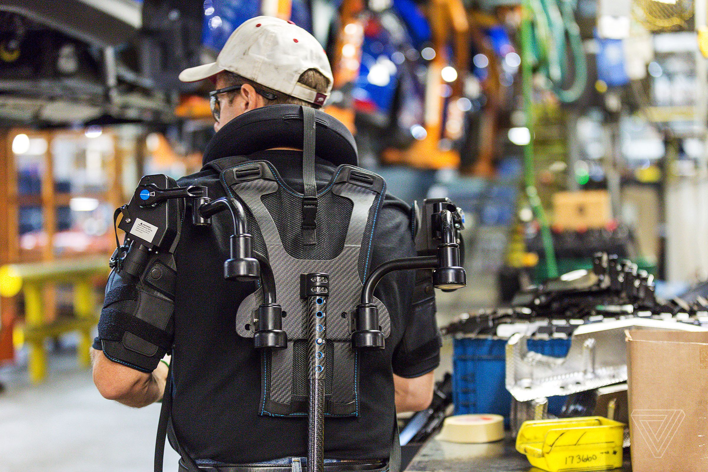 Ford assembly line worker Paul Collins wears an Ekso vest.