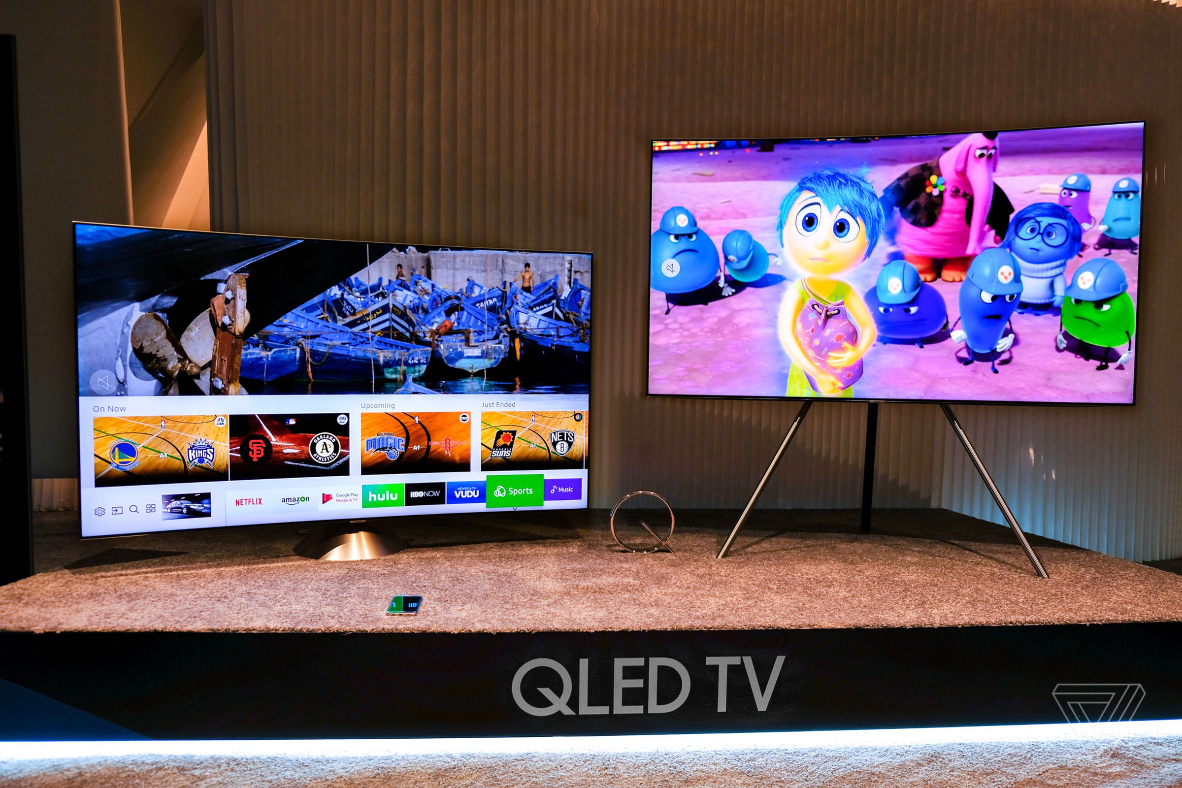 Samsung’s QLED TVs can be used with an easel-like stand or a metal “gravity stand.” 
