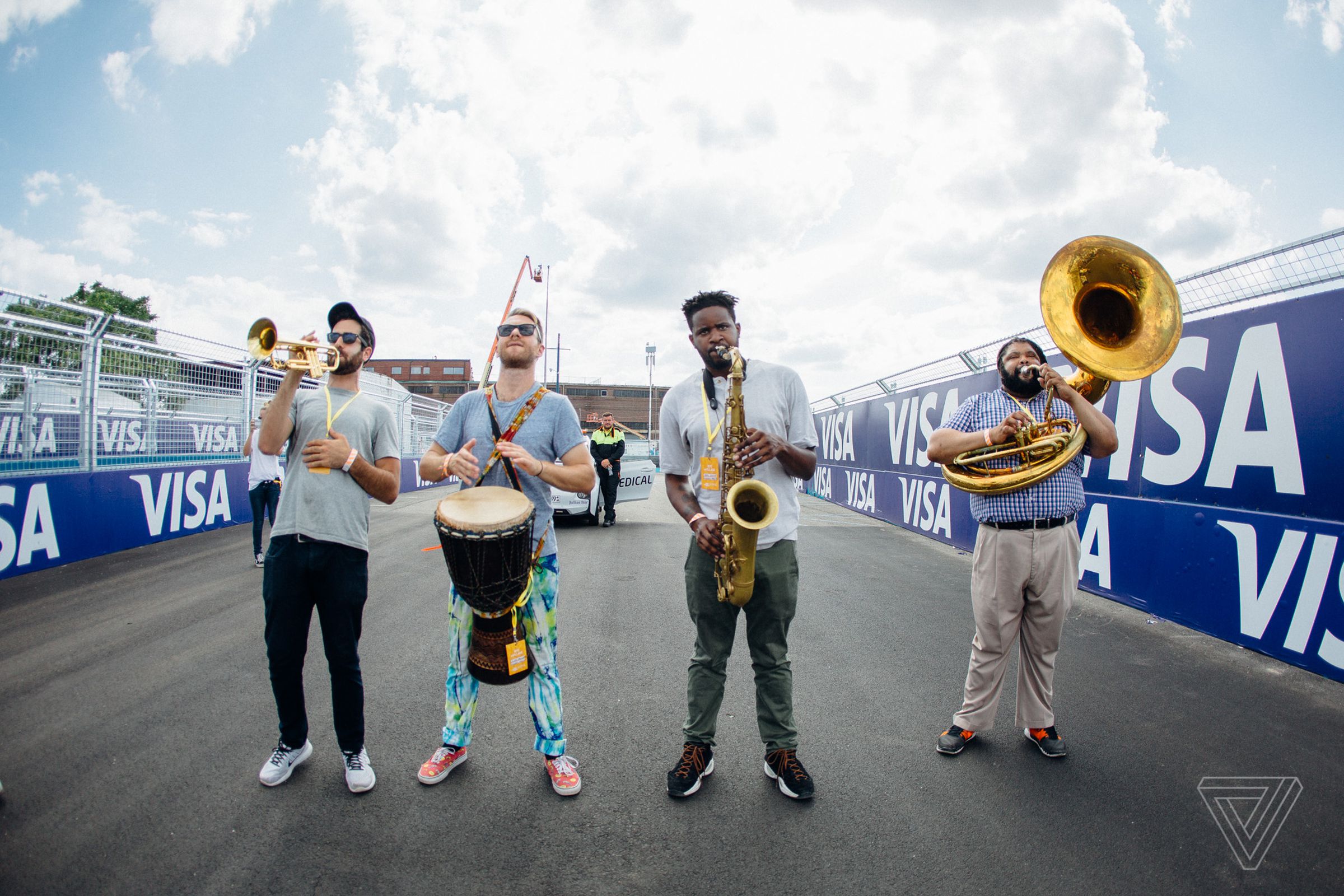 A local band plays some New Orleans second line standards while the fans walk the starting grid. 