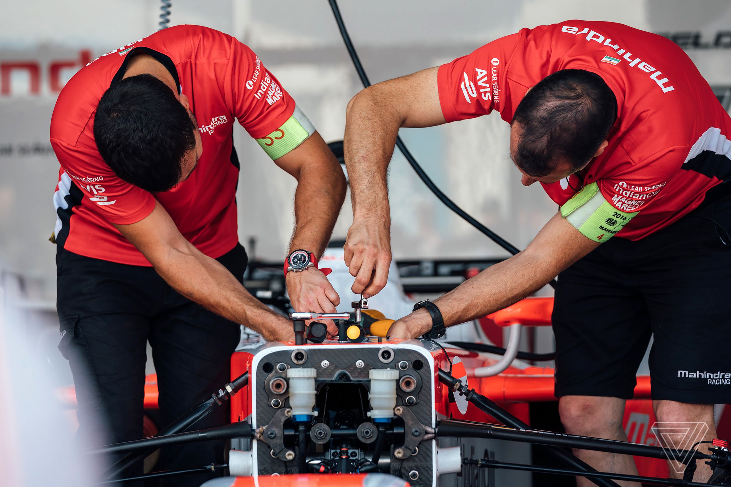 Crew members for Nick Heidfeld’s #23 Mahindra Racing car go to work on the front suspension in between practice sessions.