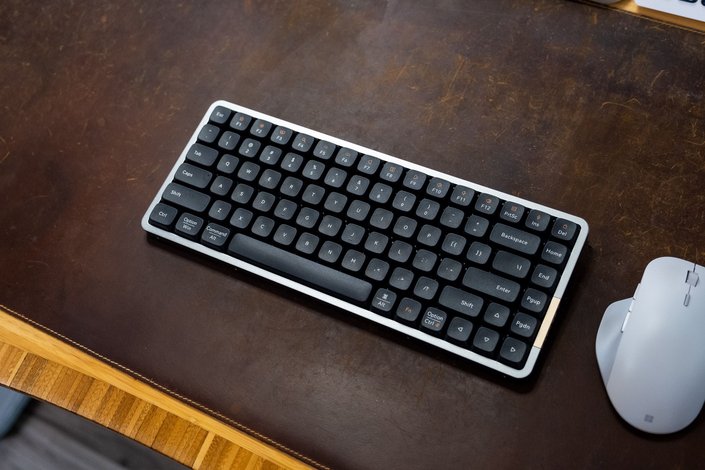 Lofree Flow keyboard on a brown deskmat, viewed from above.