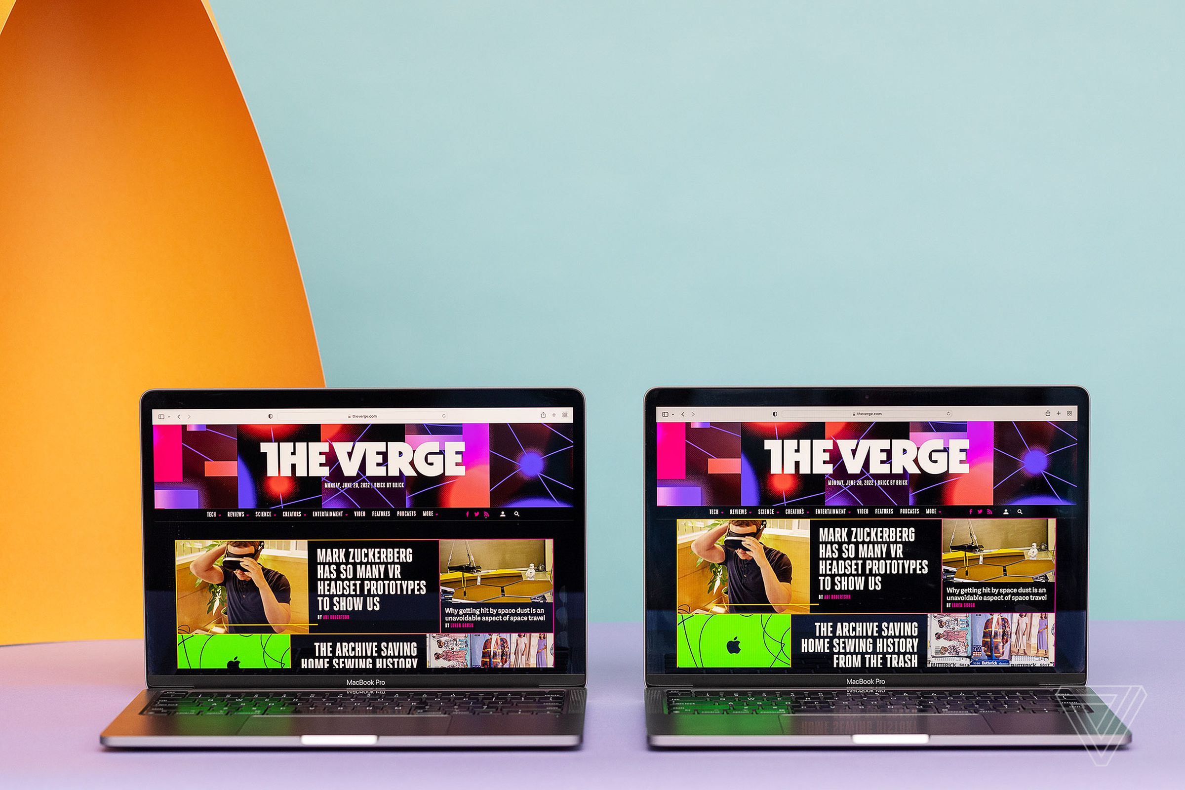 The Apple MacBook Pro 2020 and MacBook Pro 2022 open side by side. Both screens display The Verge homepage.