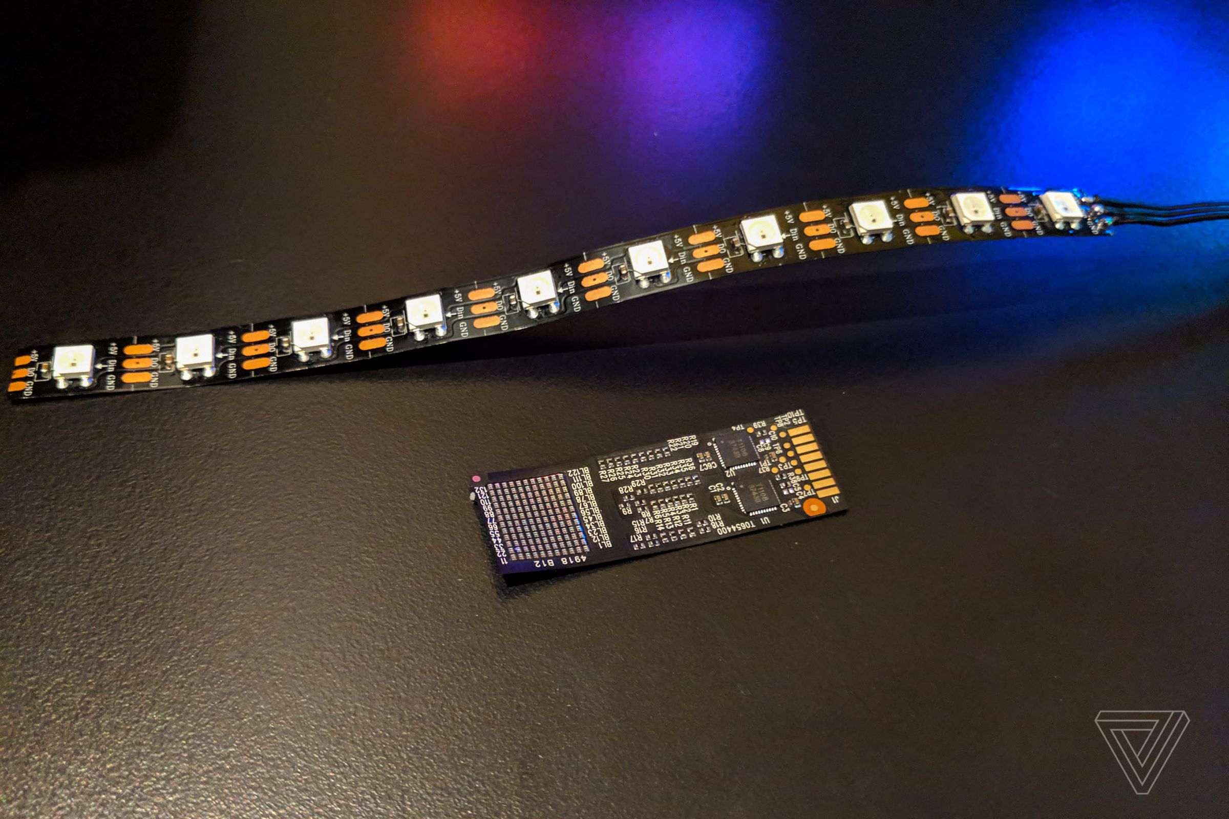 An array of dozens of Corsair Capellix LEDs next to a regular RGB LED strip with 10 lights on it.