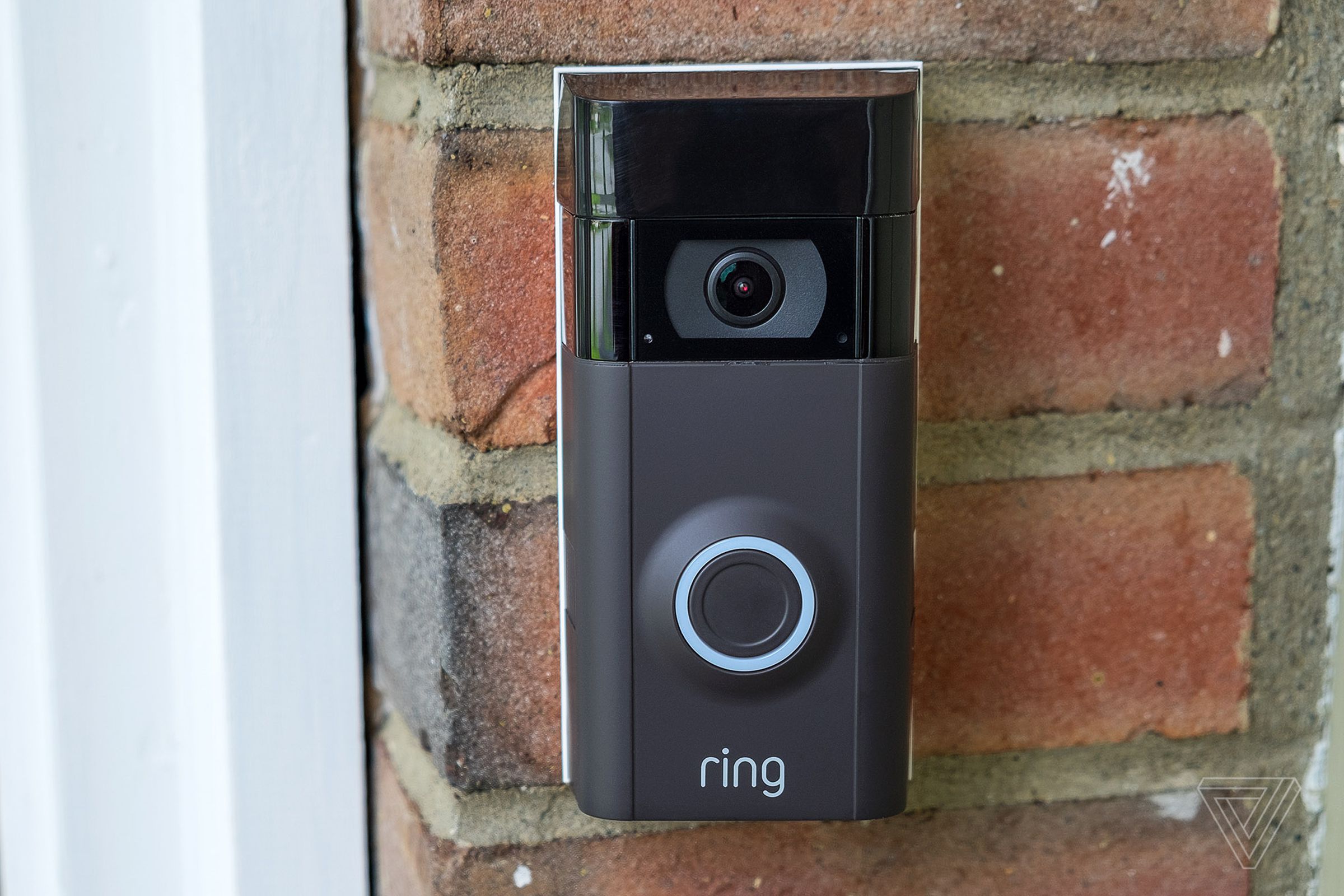 Ring video doorbell mounted on house