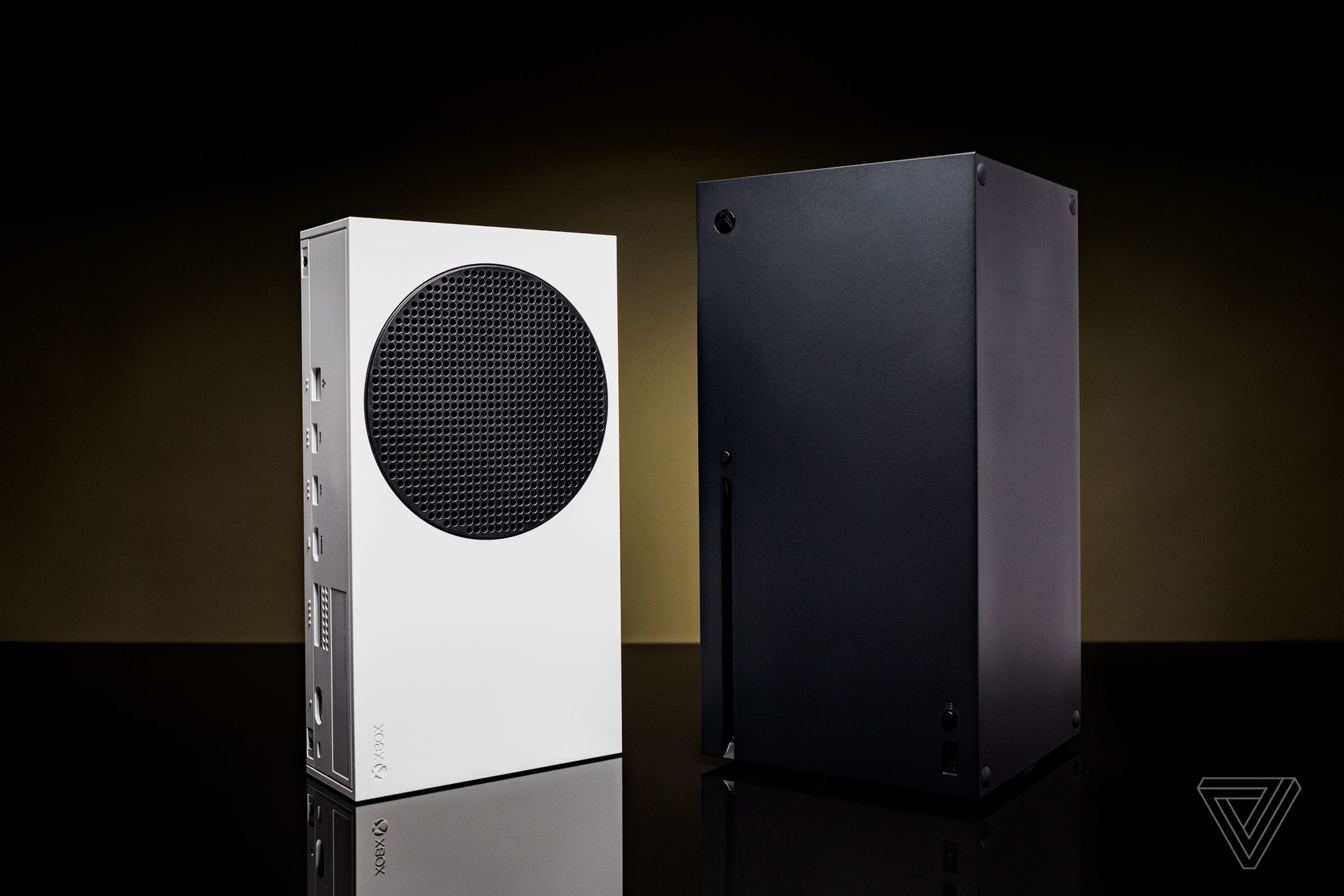 The white Xbox Series S and black Xbox Series X consoles standing side by side.