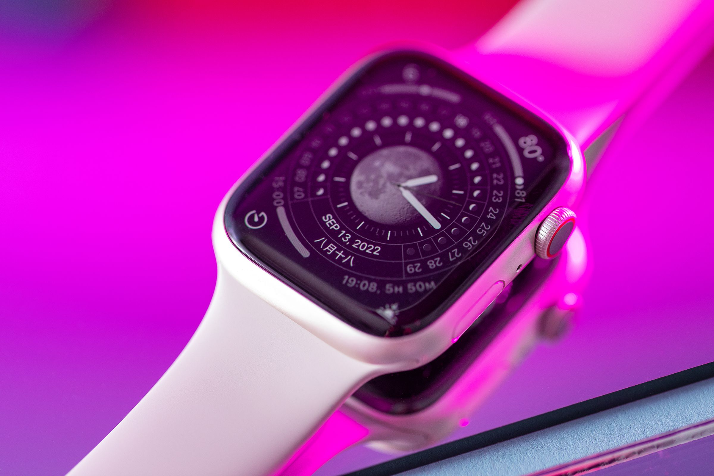 The Apple Watch Series 8 on a reflective pink mirror