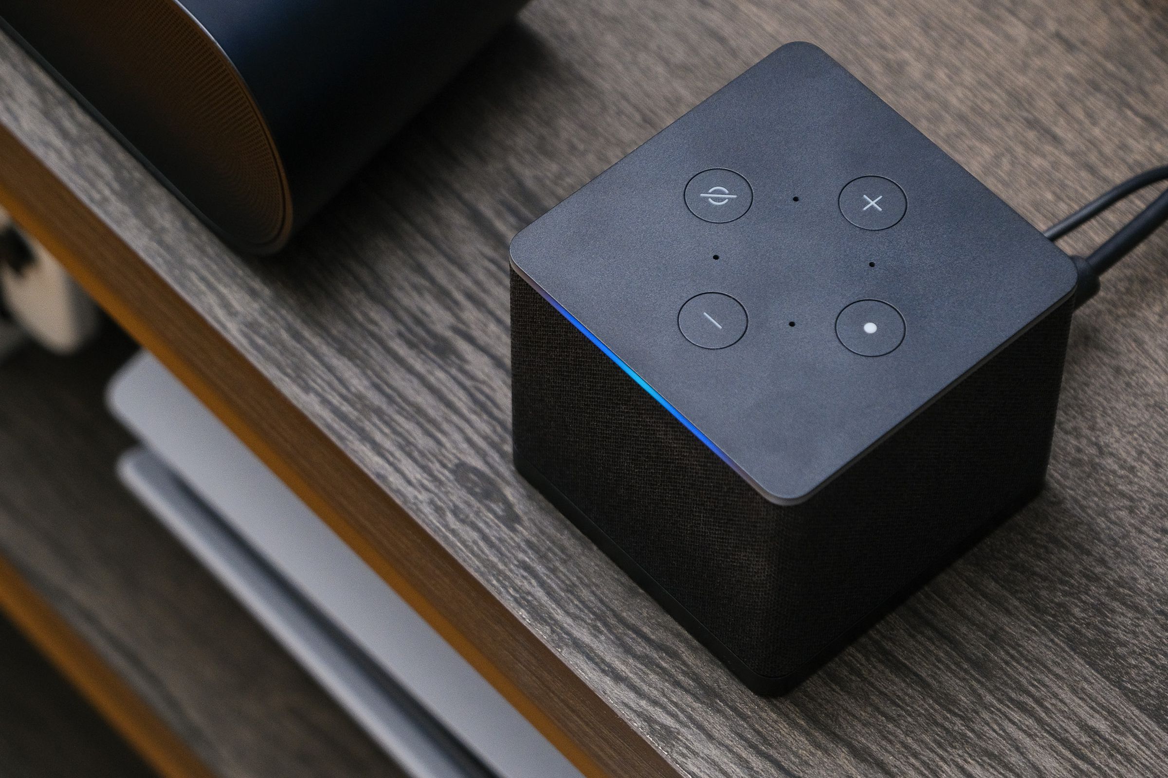 A photo of Amazon’s Fire TV Cube on a TV stand.
