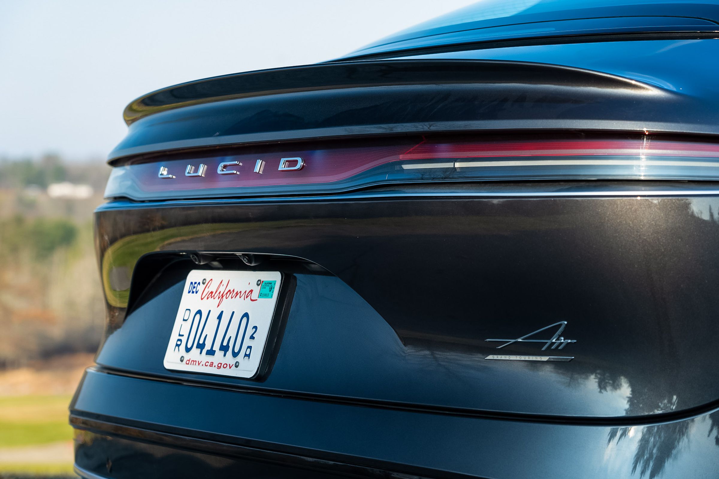 Photo of the Lucid logo on the back of an Air sedan.