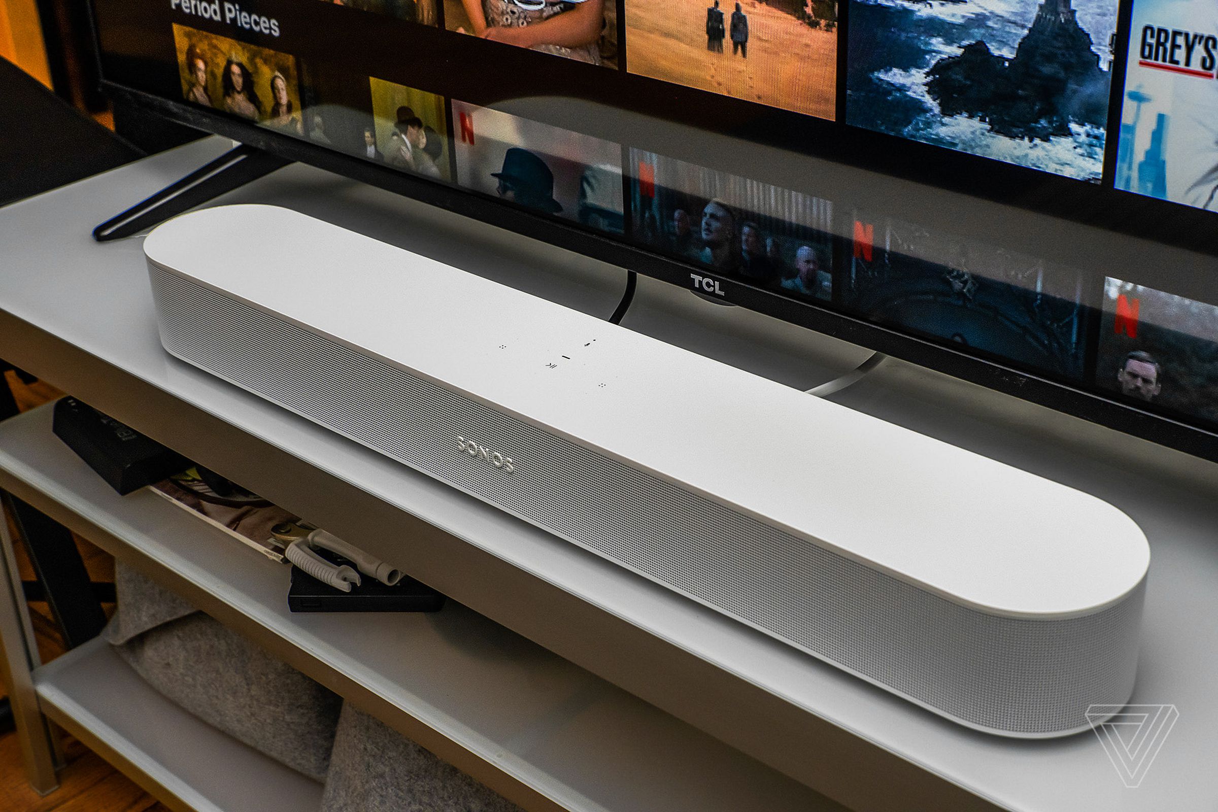 A photo of the white second-generation Sonos Beam soundbar in front of a TV