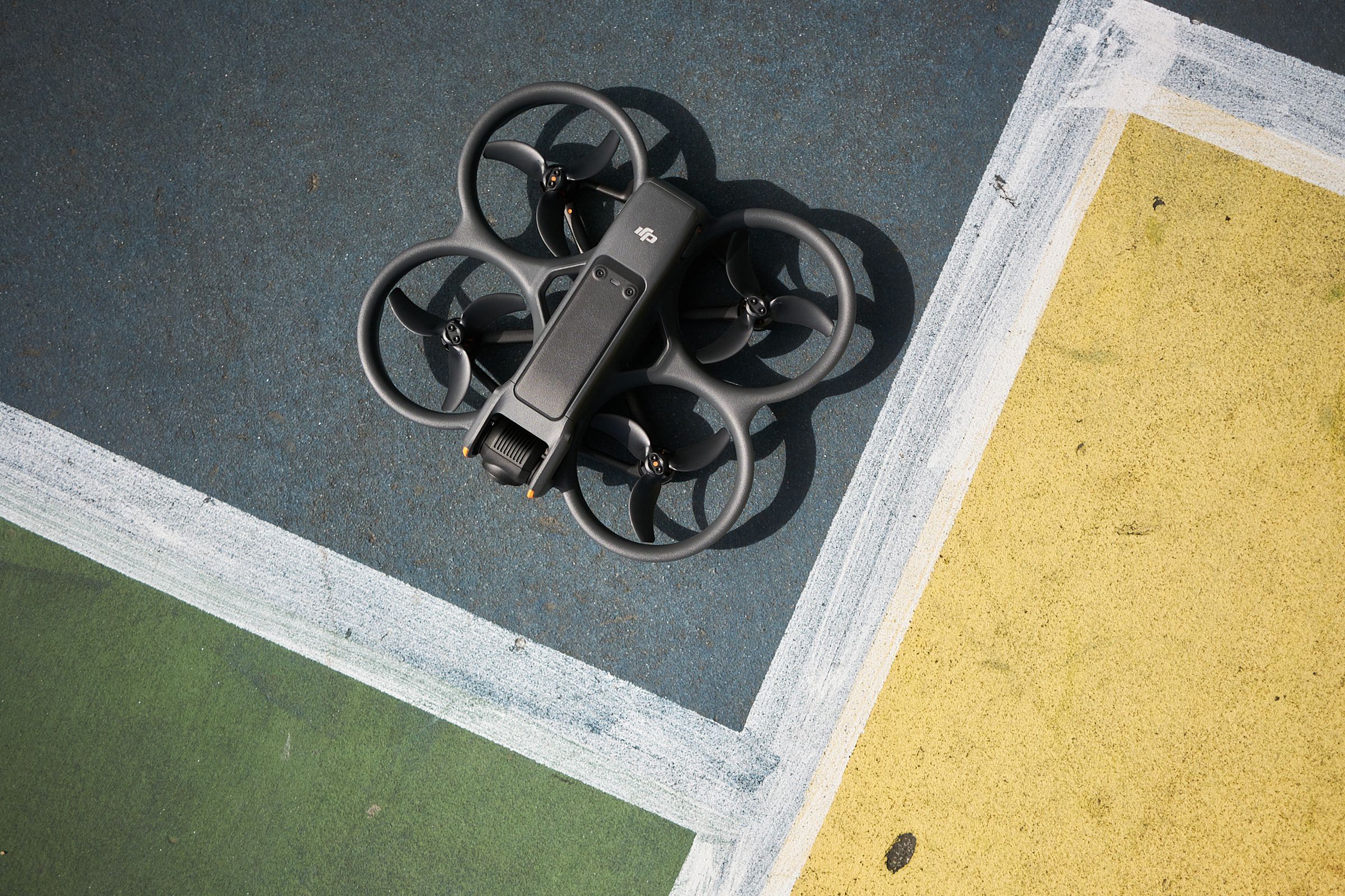 A photo showing DJI’s Avata 2 drone on pavement.