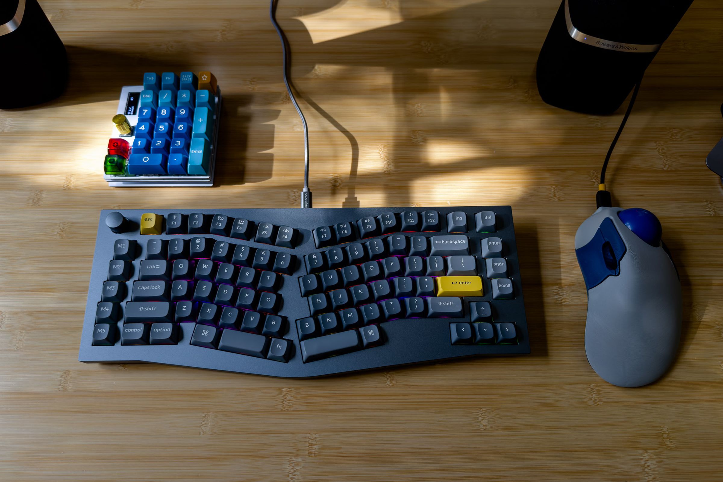 Top-down shot of a space gray Keychron Q10, a milled-aluminum 75 percent Alice layout keyboard, bracketed by a Ploopy trackball and a Murphpad macropad.