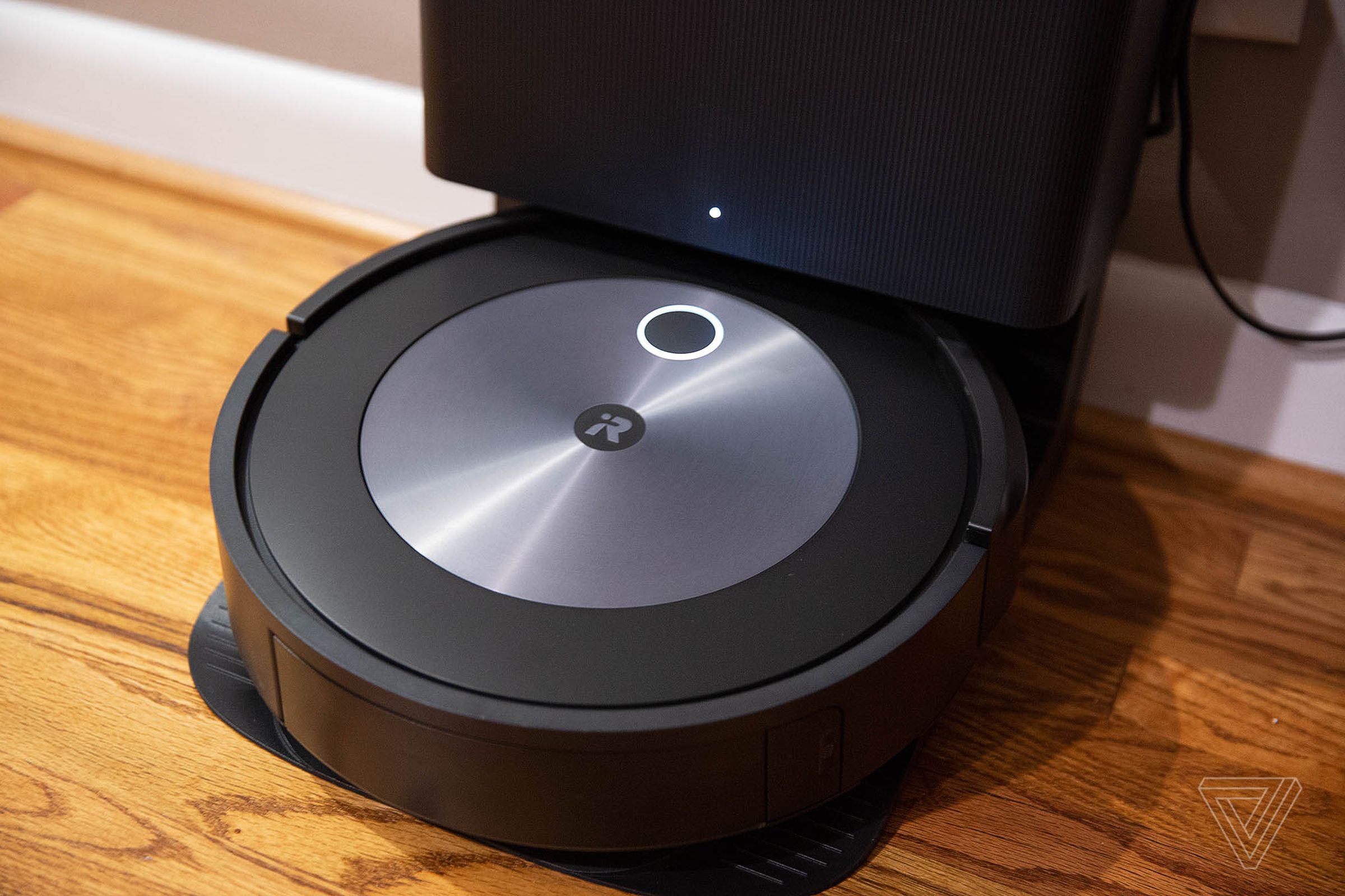 The iRobot Roomba j7 standing up against the wall.