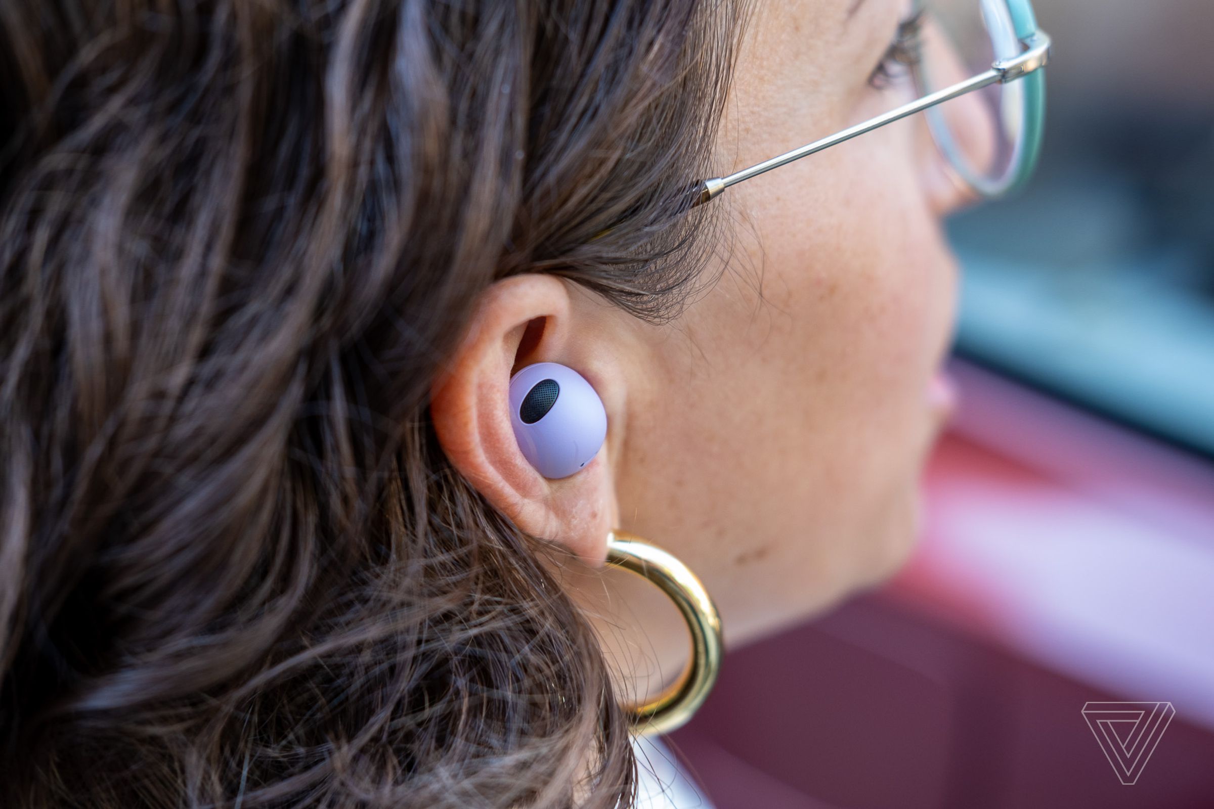 A photo of Samsung’s Galaxy Buds 2 Pro in a woman’s ear.