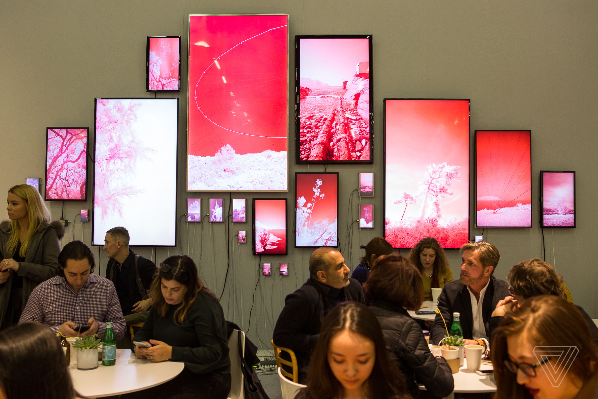 Evan Roth’s Landscapes hangs over visitors to The Armory Art Fair on pier 94 in Manhattan. Each screen displays video streamed from servers located in the country where it was recorded. There are eight different countries represented.