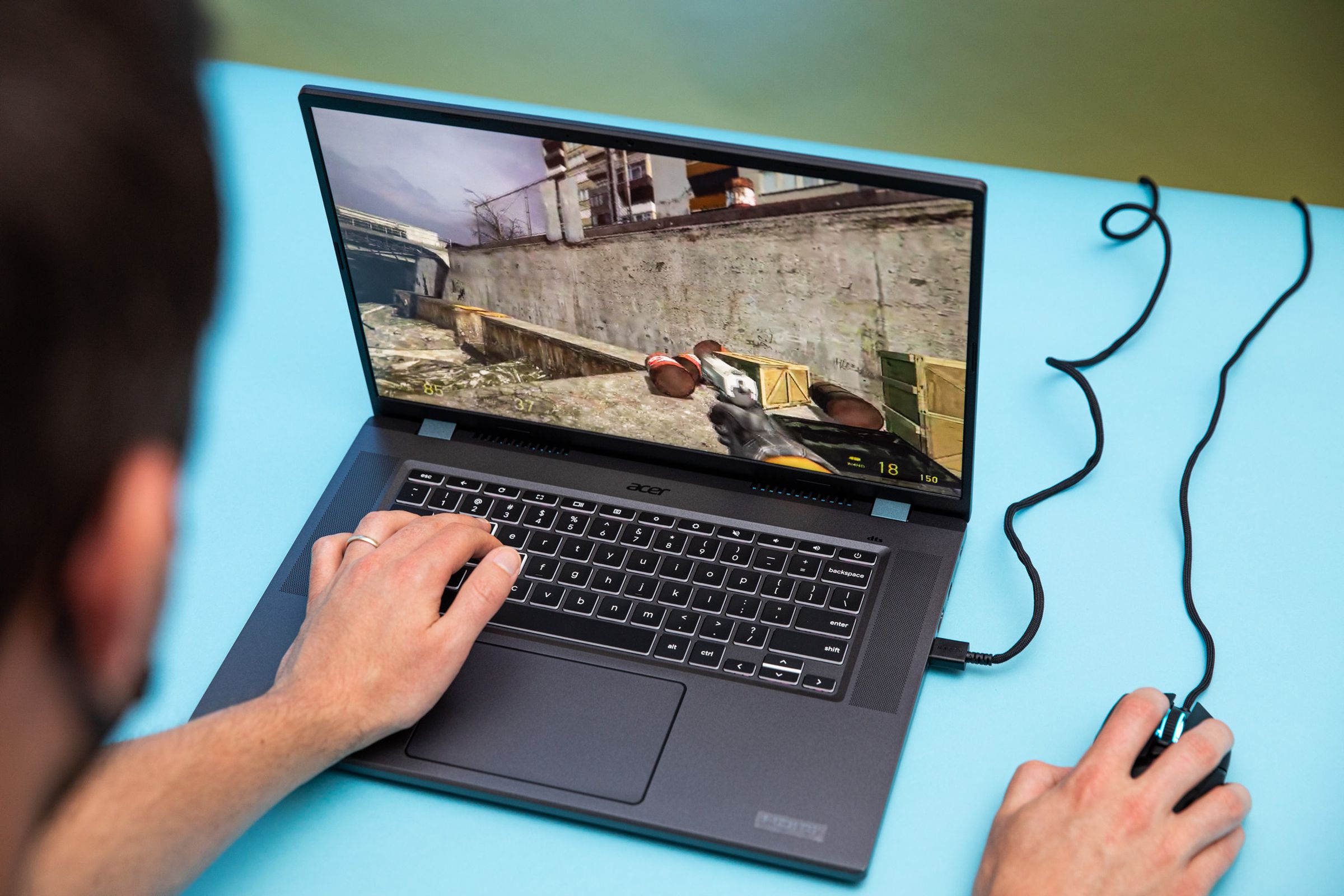 The Acer Chromebook 516 GE gaming laptop with a mouse plugged into its USB port. It’s running the game Half-Life 2.