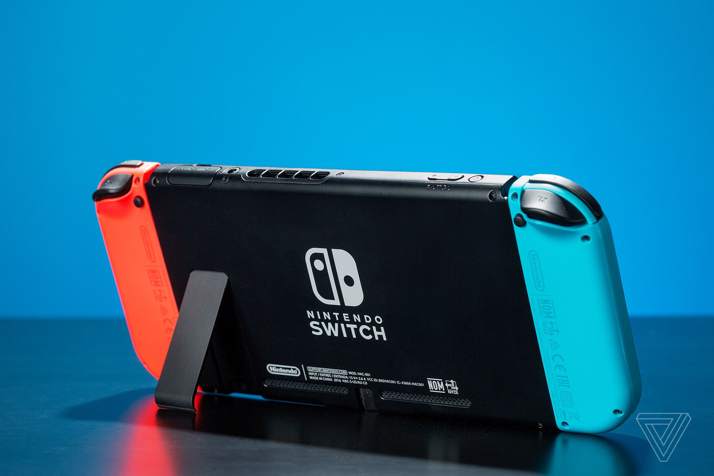 An image of a Nintendo Switch on a table with its kickstand extended.