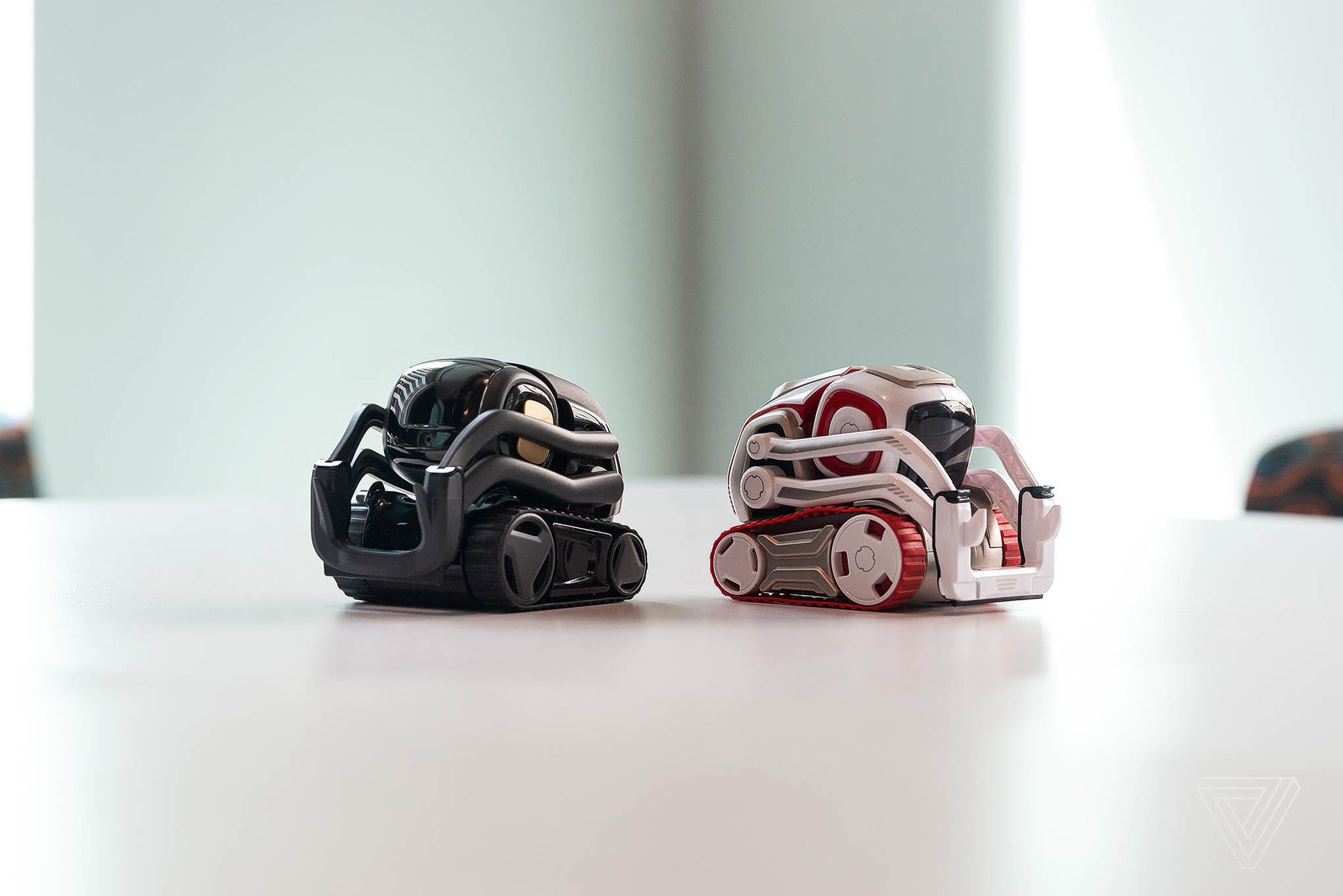 Vector on the left, Cozmo on the right.