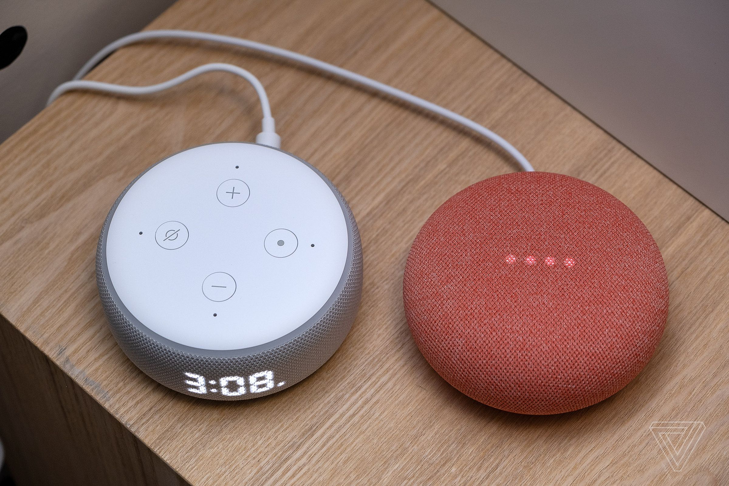 The Echo Dot with clock (left) next to the Nest Mini (right).