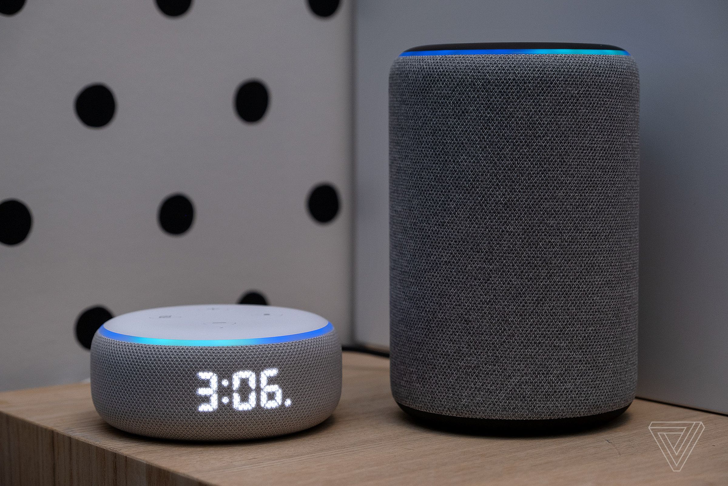The Echo Dot with clock next to the bigger Echo.