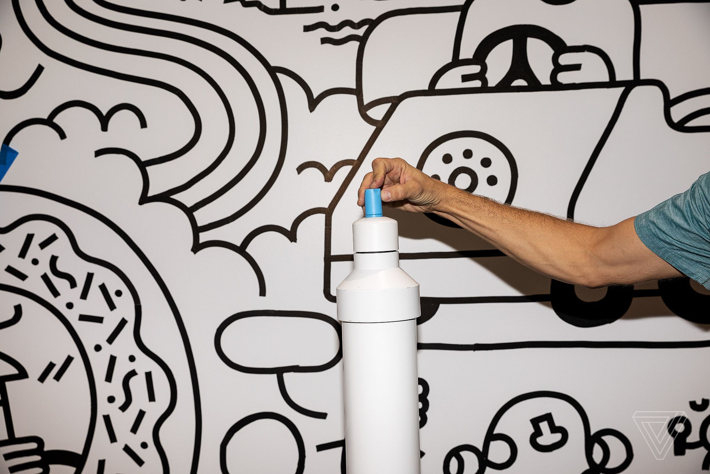 Jeff Lind poses with an oversized marker, which is part of the “Color Me ___” room by Andrew Neyer and Andy J. Pizza.