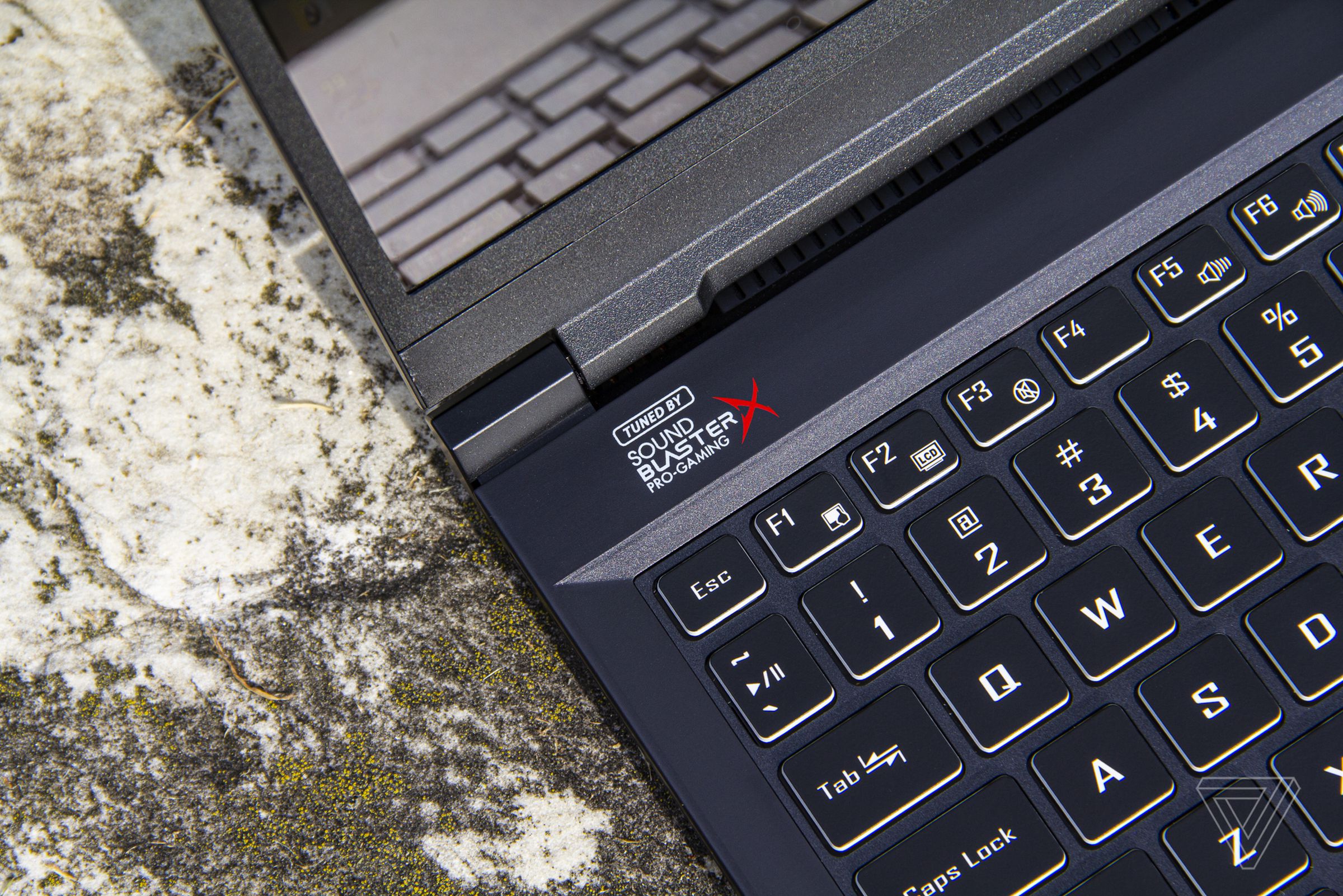 The Sound Blaster Pro-Gaming logo on the left corner of the Origin EVO15-S keyboard deck, up close.