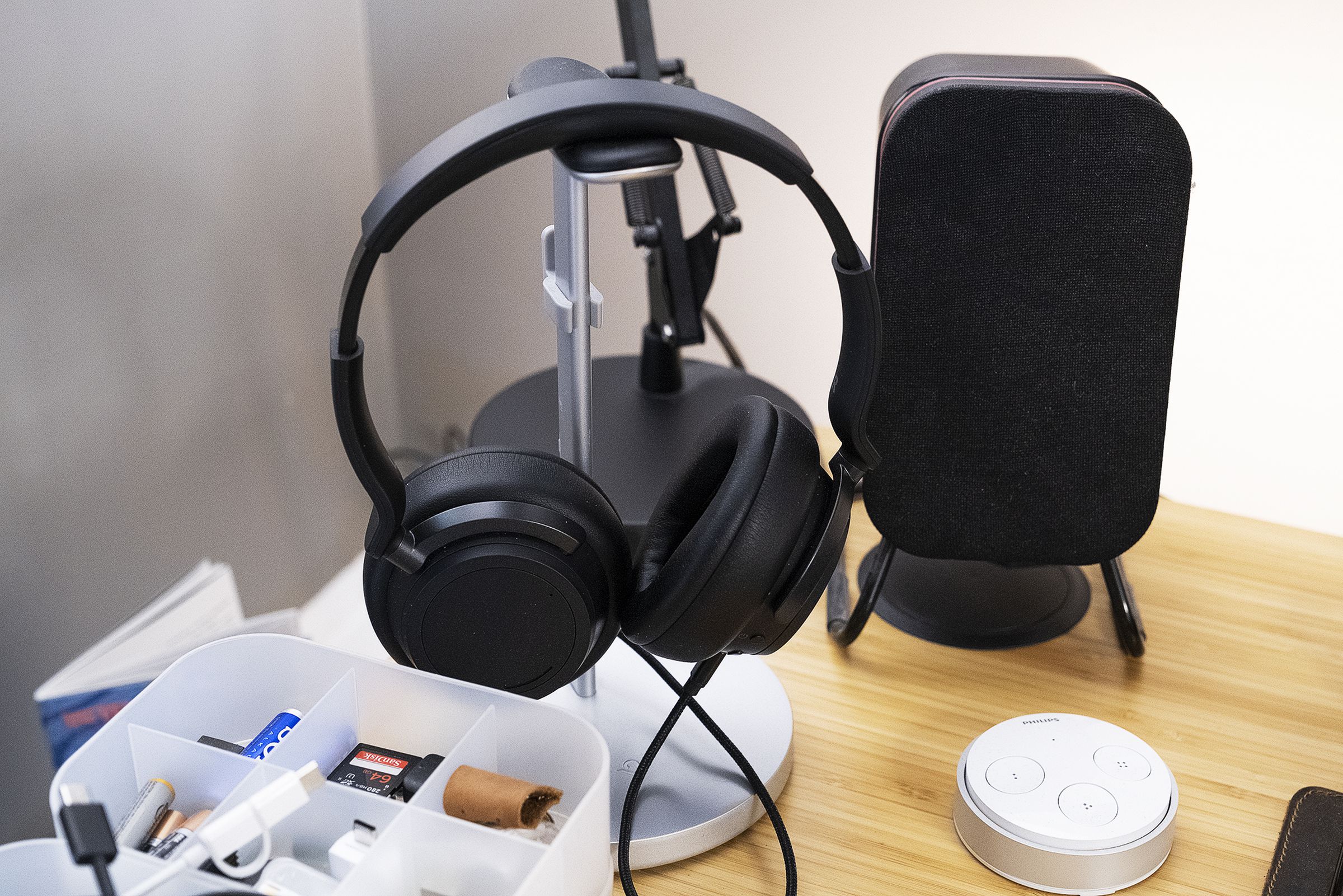 A set of Microsoft Surface Headphones 2 next to a long-discontinued speaker from Audyssey.