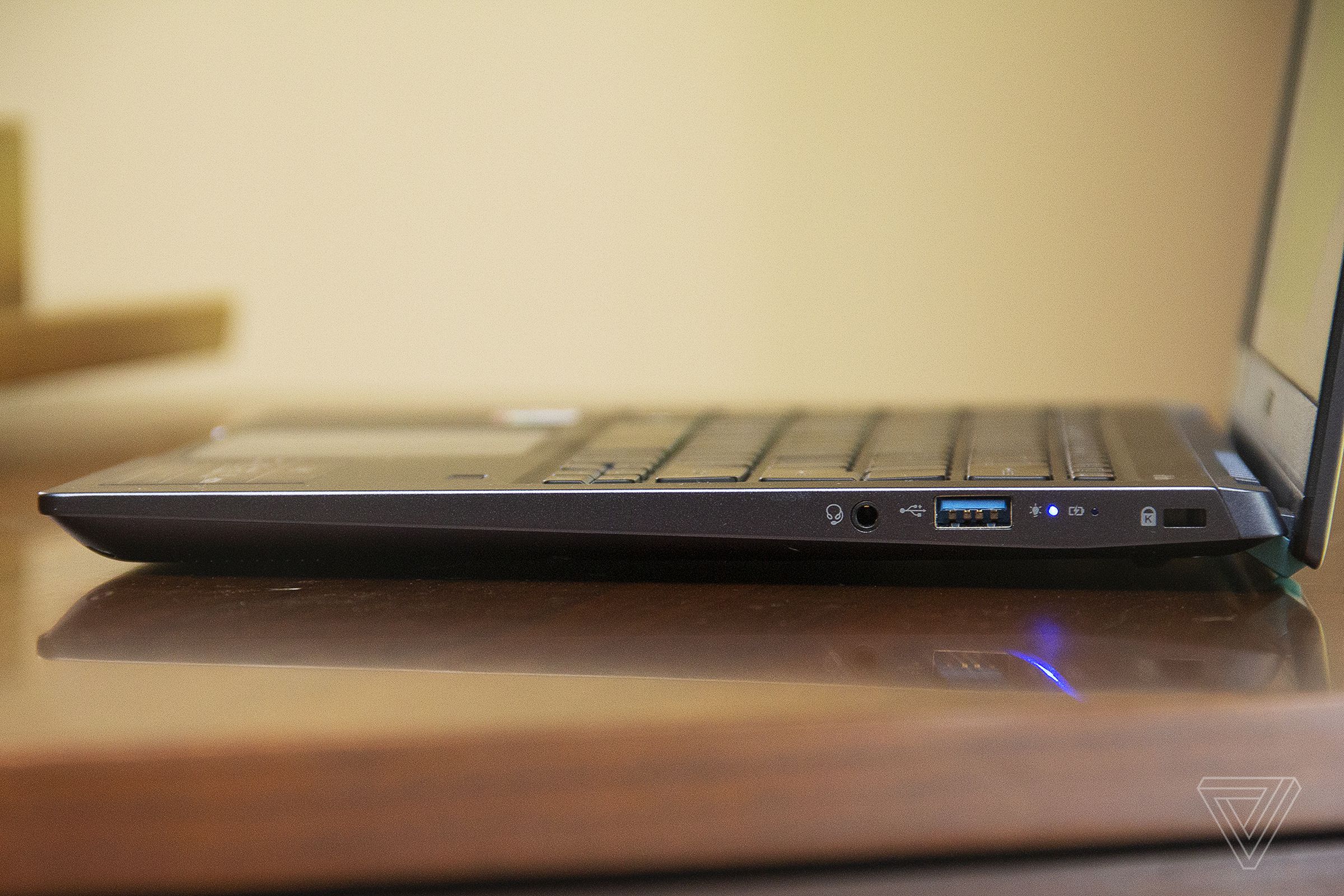 The Acer Swift 3X open on a piano, seen from the left side.