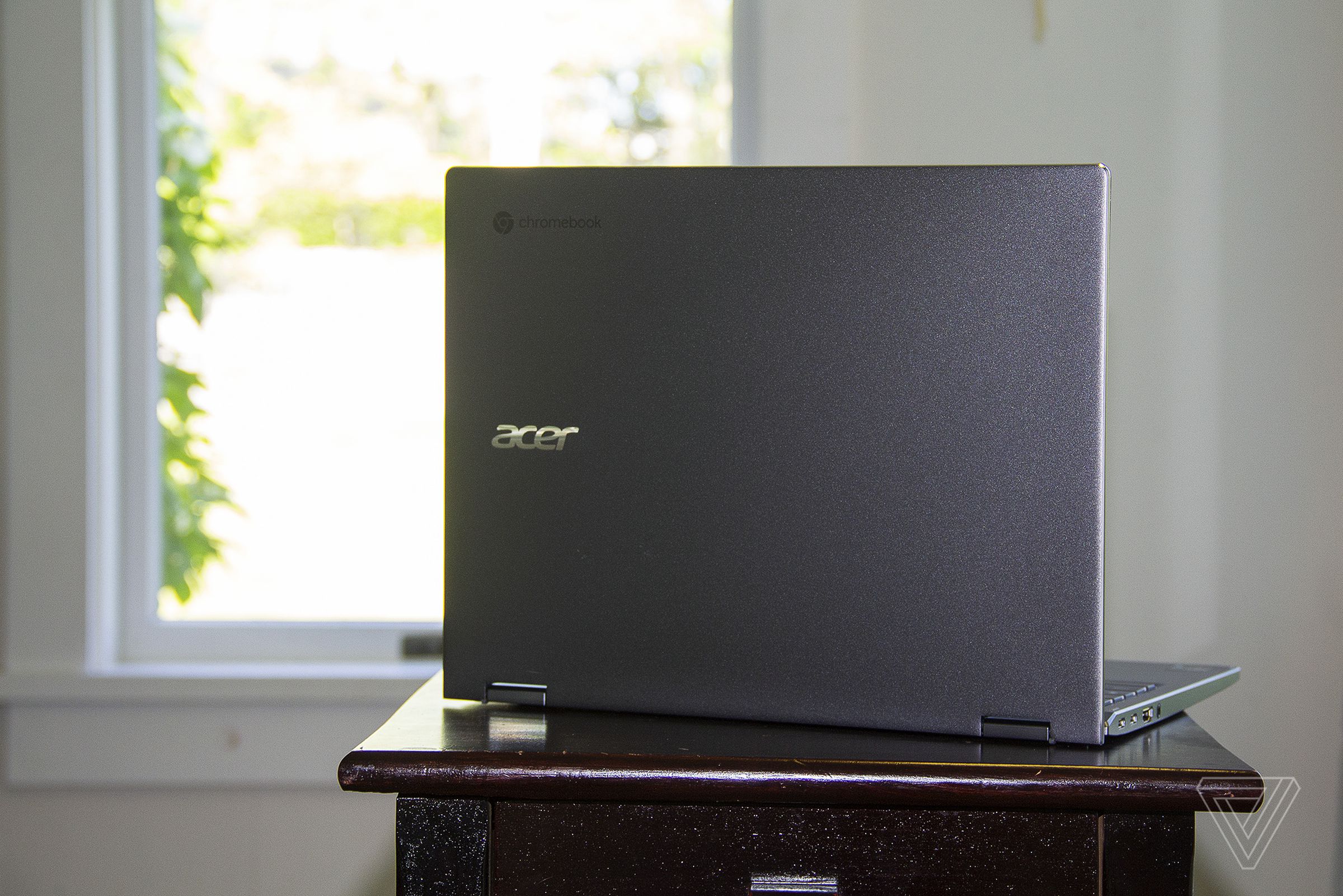 The Acer Chromebook Spin 713 open on a table seen from the back, angled to the right.