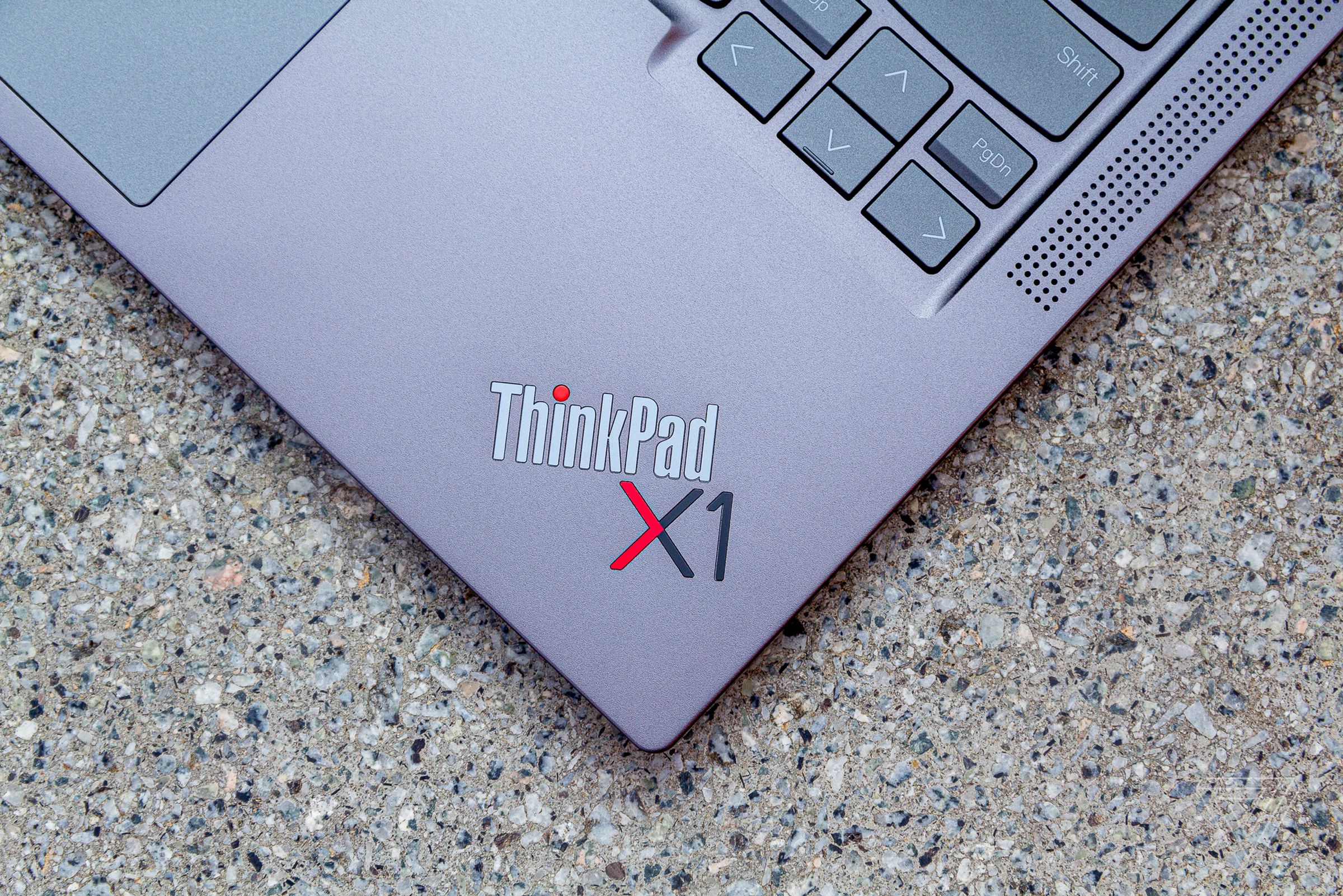 The ThinkPad X1 logo on the ThinkPad X1 Yoga Gen 6 seen from above on a stone table.