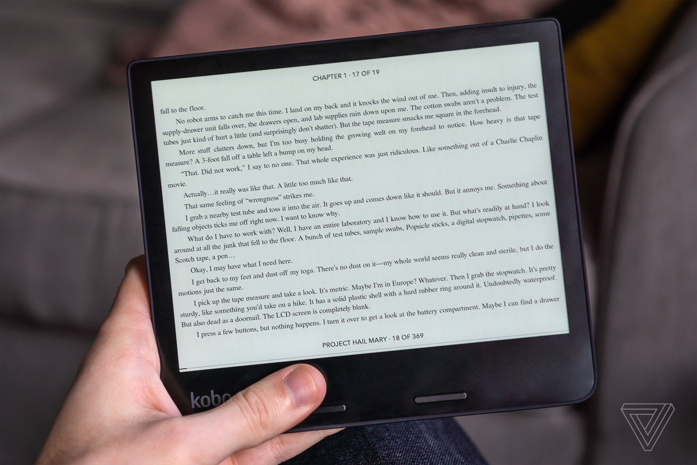Picture of a hand holding a Kobo e-reader.