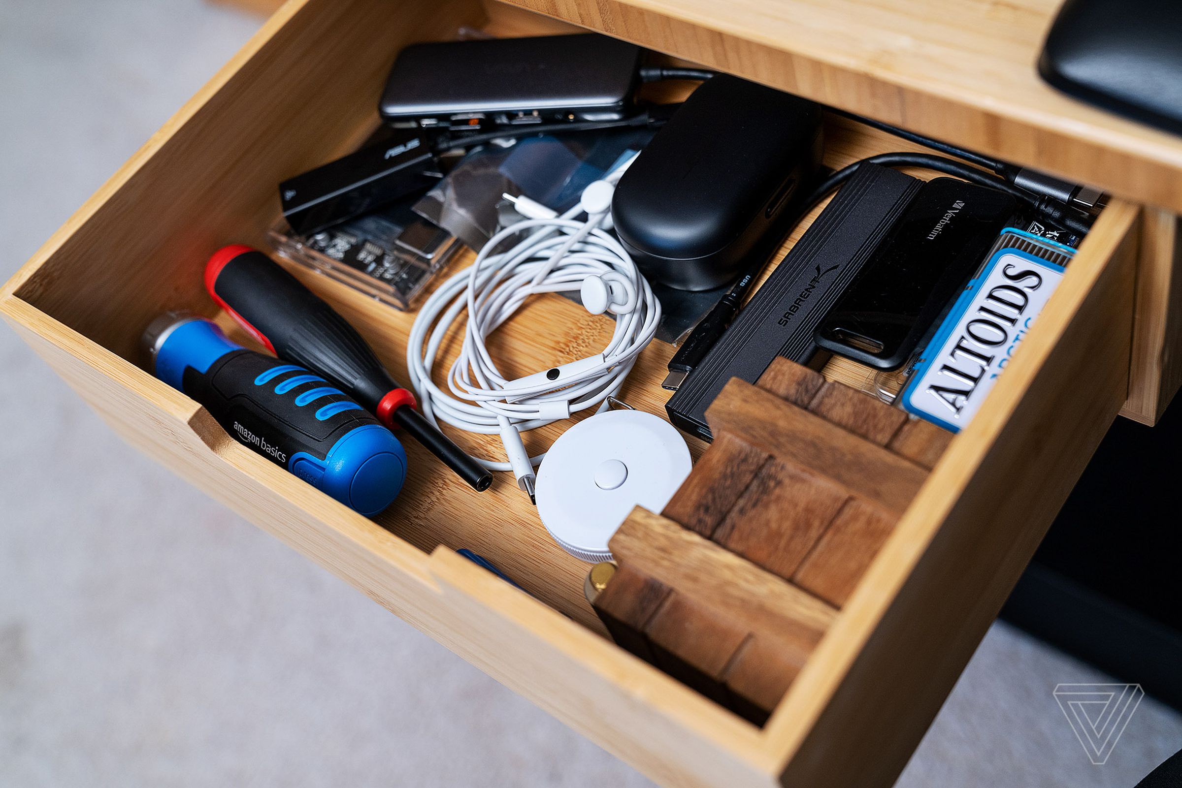 A drawer holds screwdrivers, USB-C gear and other gadgets.