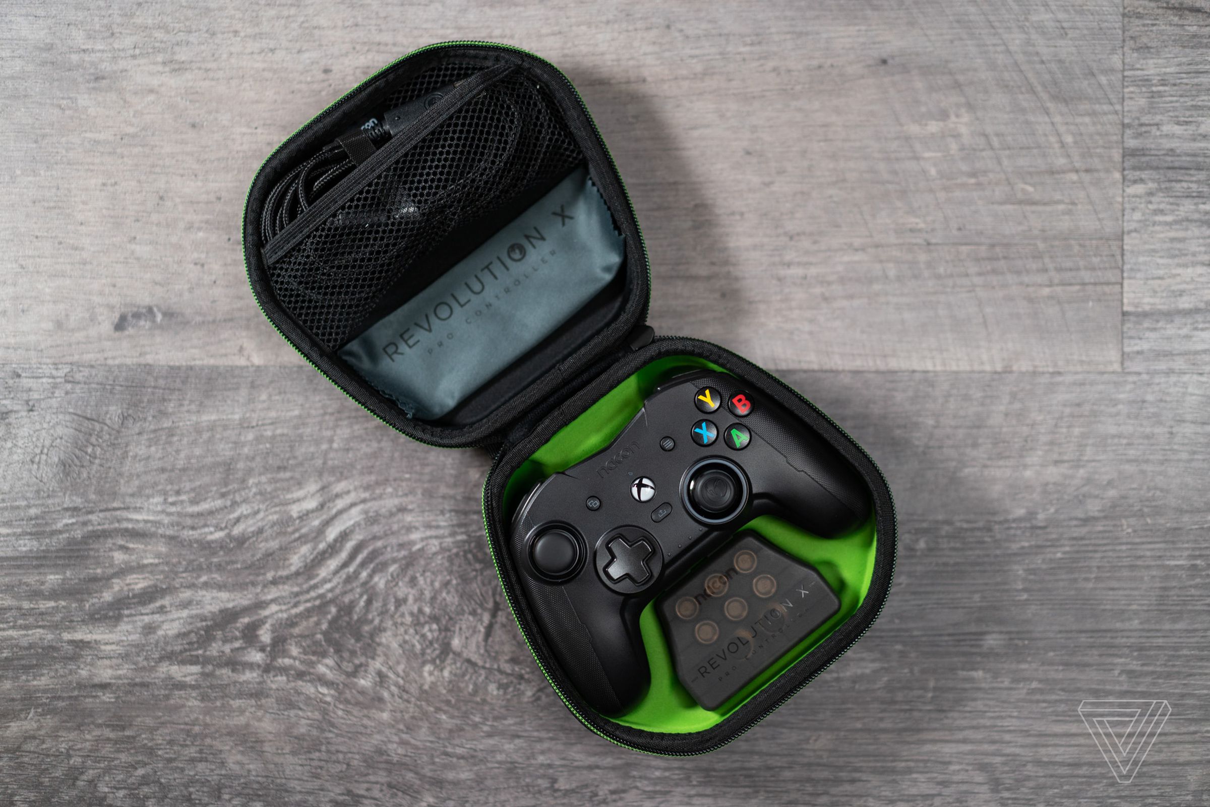 The Nacon Revolution X controller resting in its included carrying case, with all its accessories.