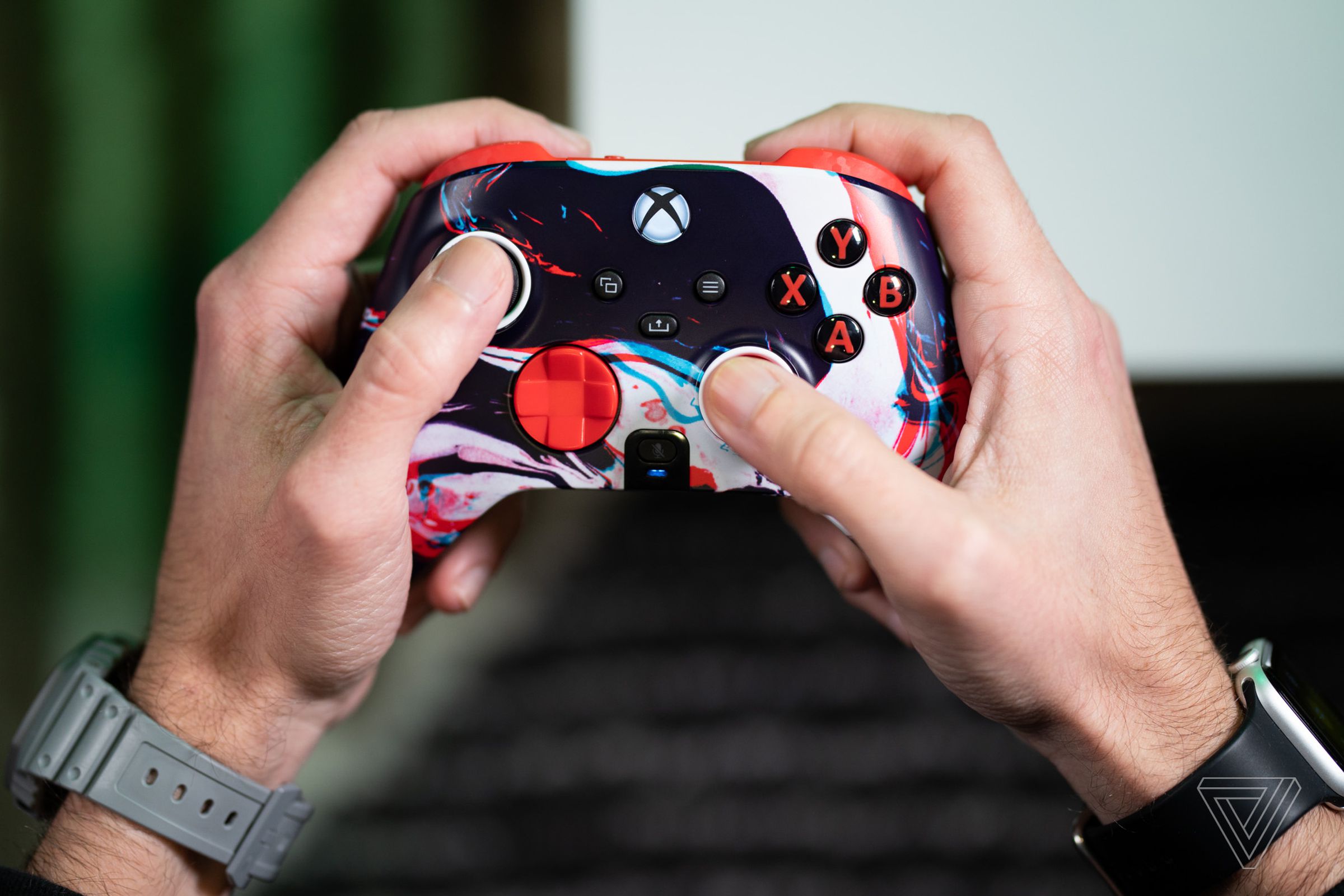 A pair of hands holding and using the Scuf Instinct Pro controller for Xbox.