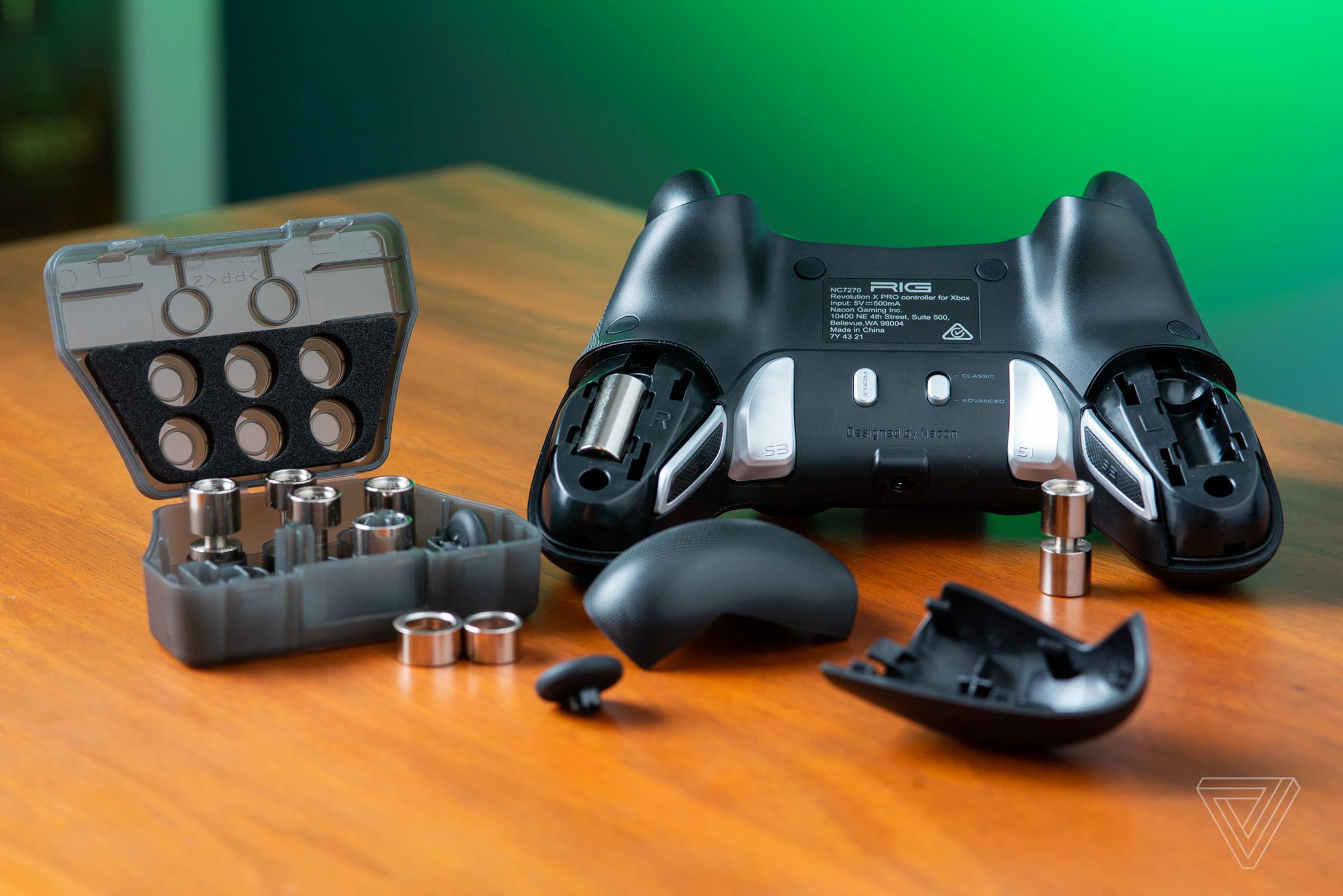 The rear of the Nacon Revolution X controller with its swappable weights and thumb stick toppers.