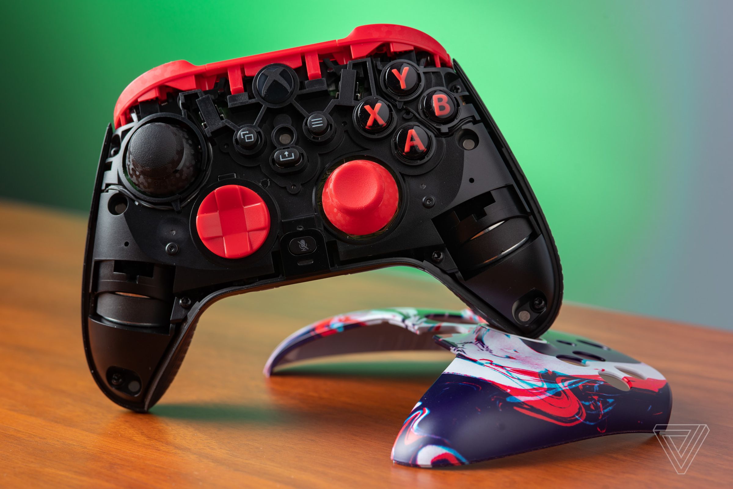 The Scuf Instinct Pro Xbox controller resting on its detached magnetic faceplate.