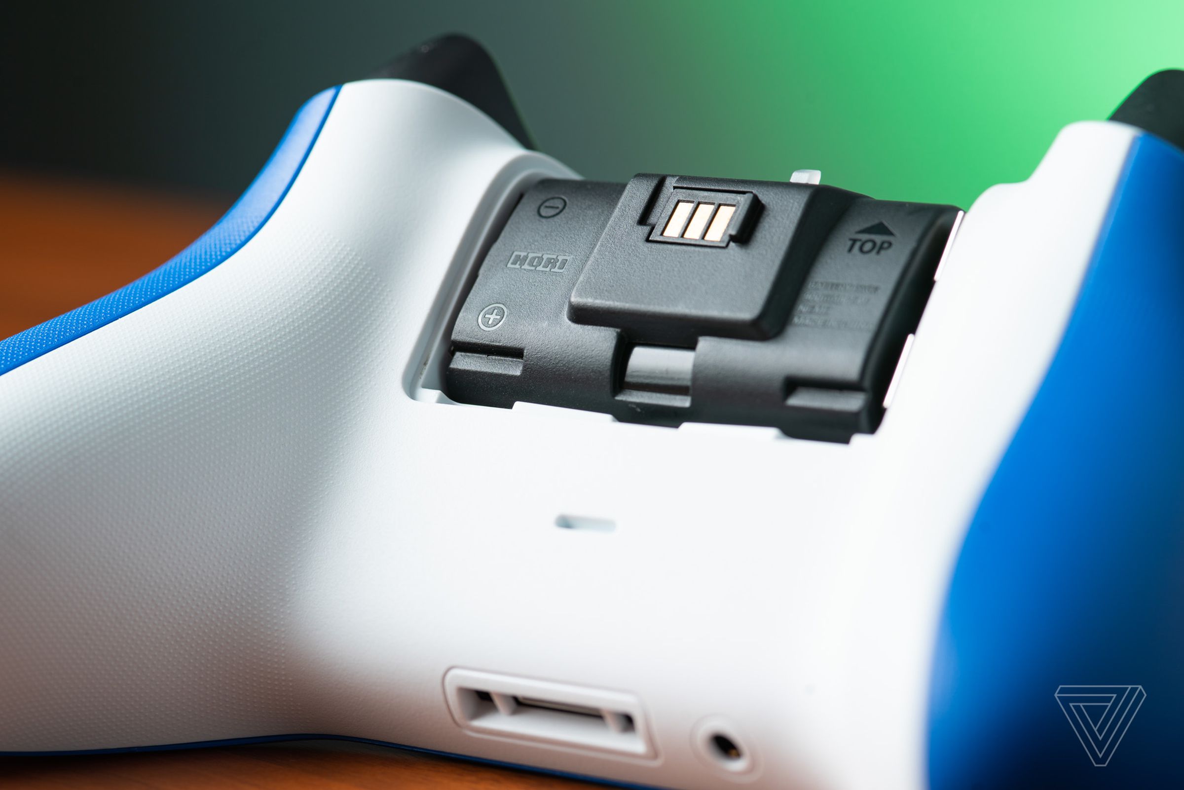 A closeup of a Hori rechargeable battery pack inserted into an Xbox controller.