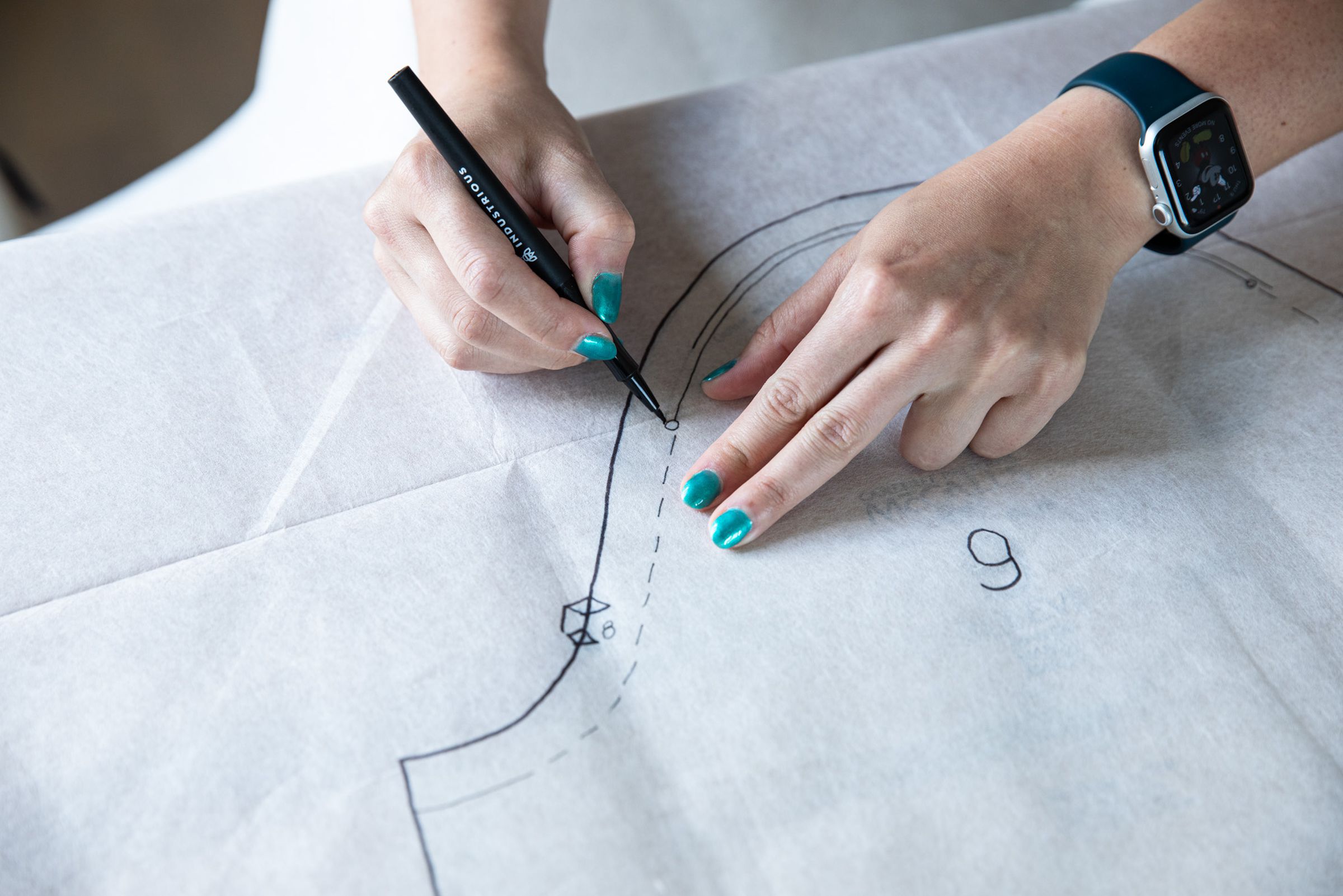 Verge reporter Mia Sato works on a dress from a vintage pattern at a makeshift sewing station — her dining room table.