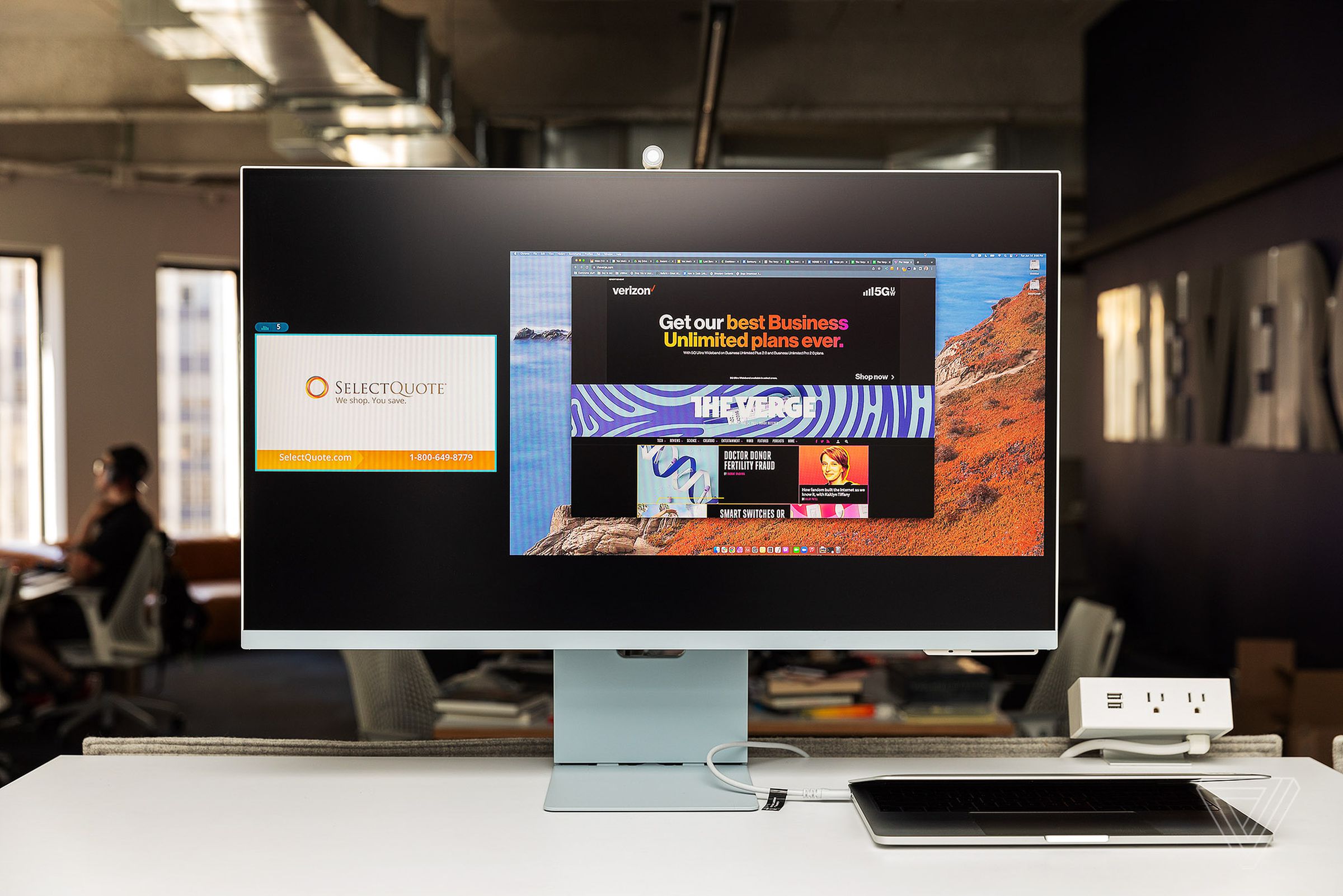The M8 in side-by-side view mode, with a TV image in the left third of the screen and a MacOS desktop in the right two-thirds. Both are in 16:9 aspect ratio and are letterboxed