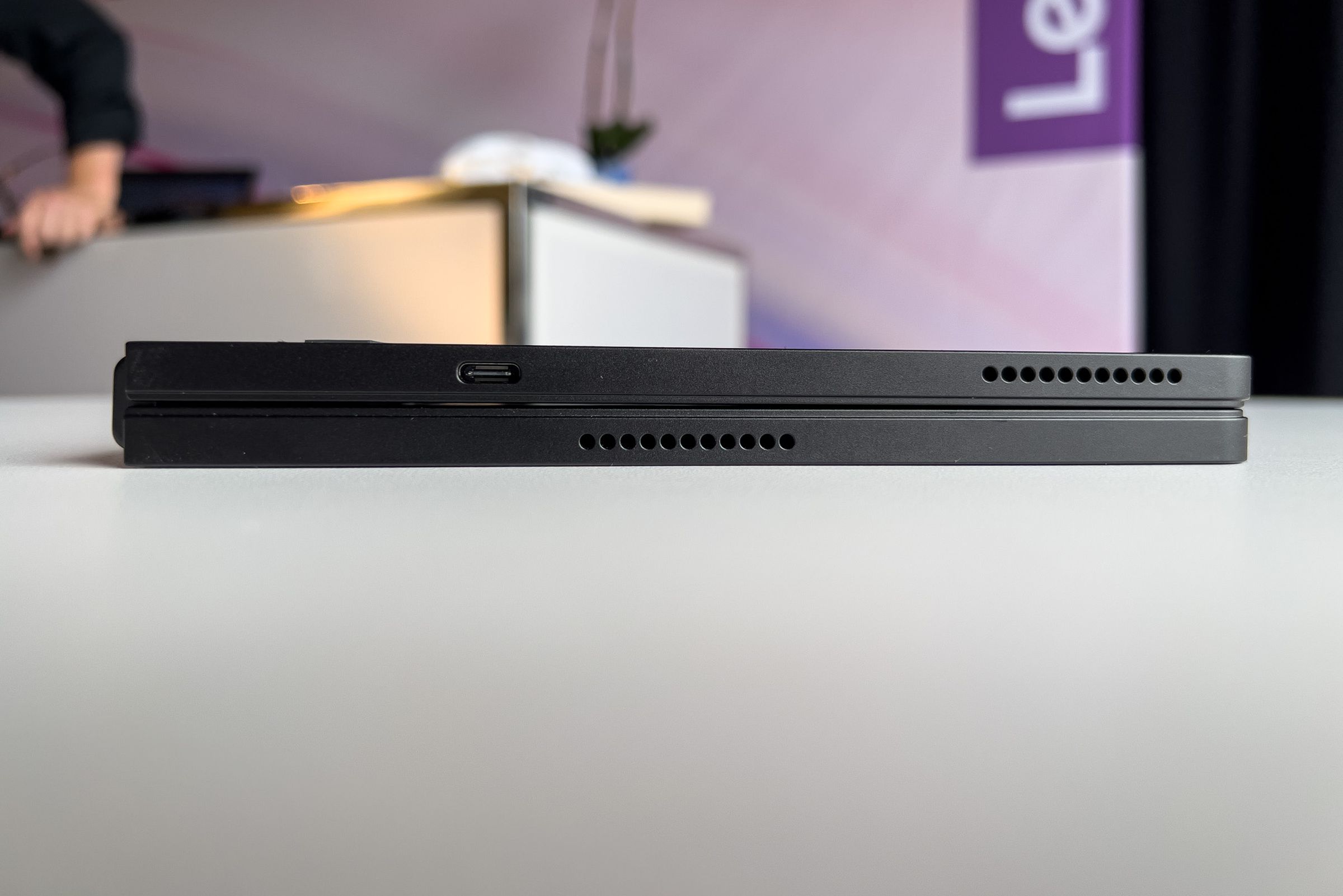 The Lenovo ThinkPad X1 Fold seen from the bottom, closed, in a demo area.