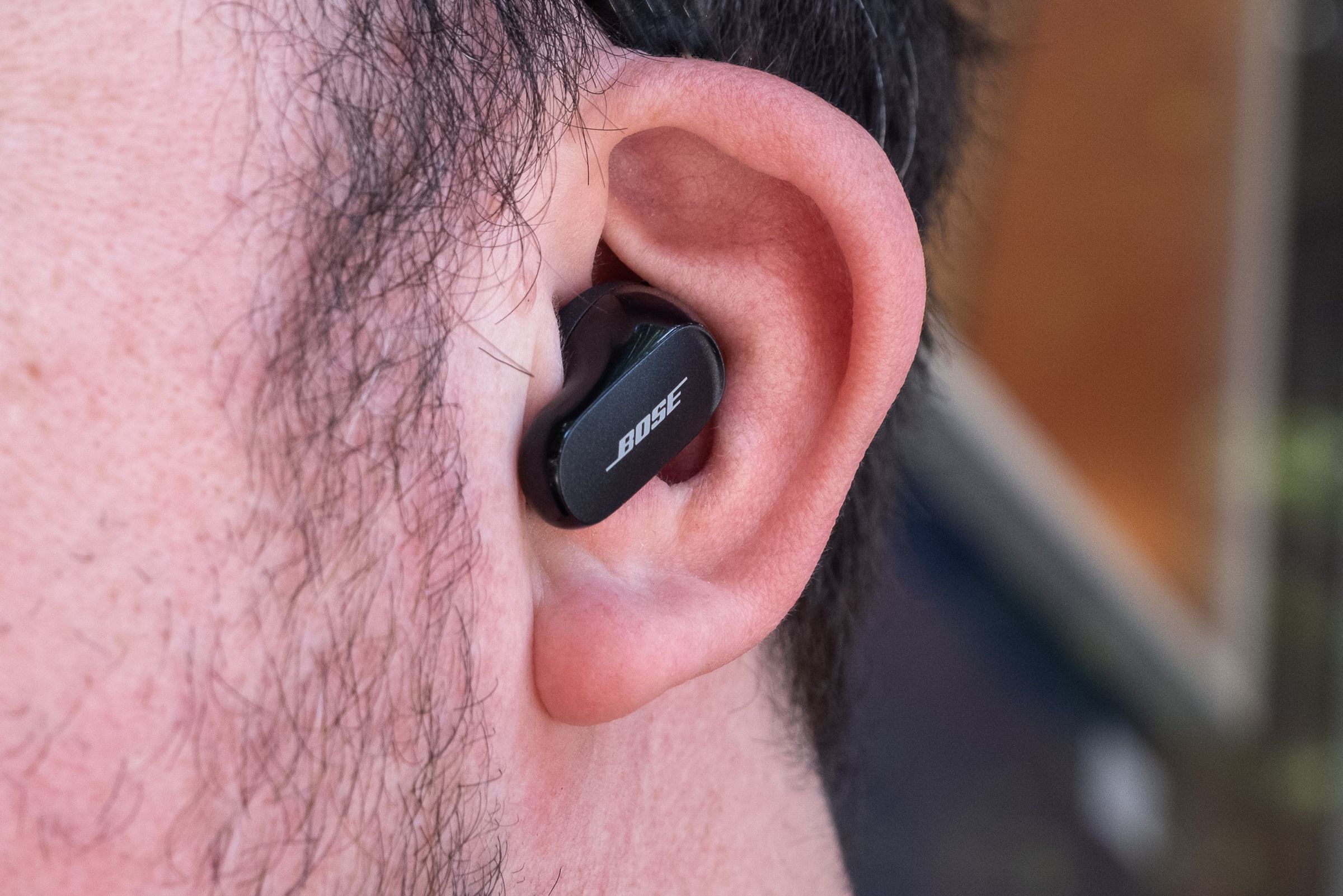 A close-up image of Bose’s QuietComfort Earbuds II in someone’s ears.