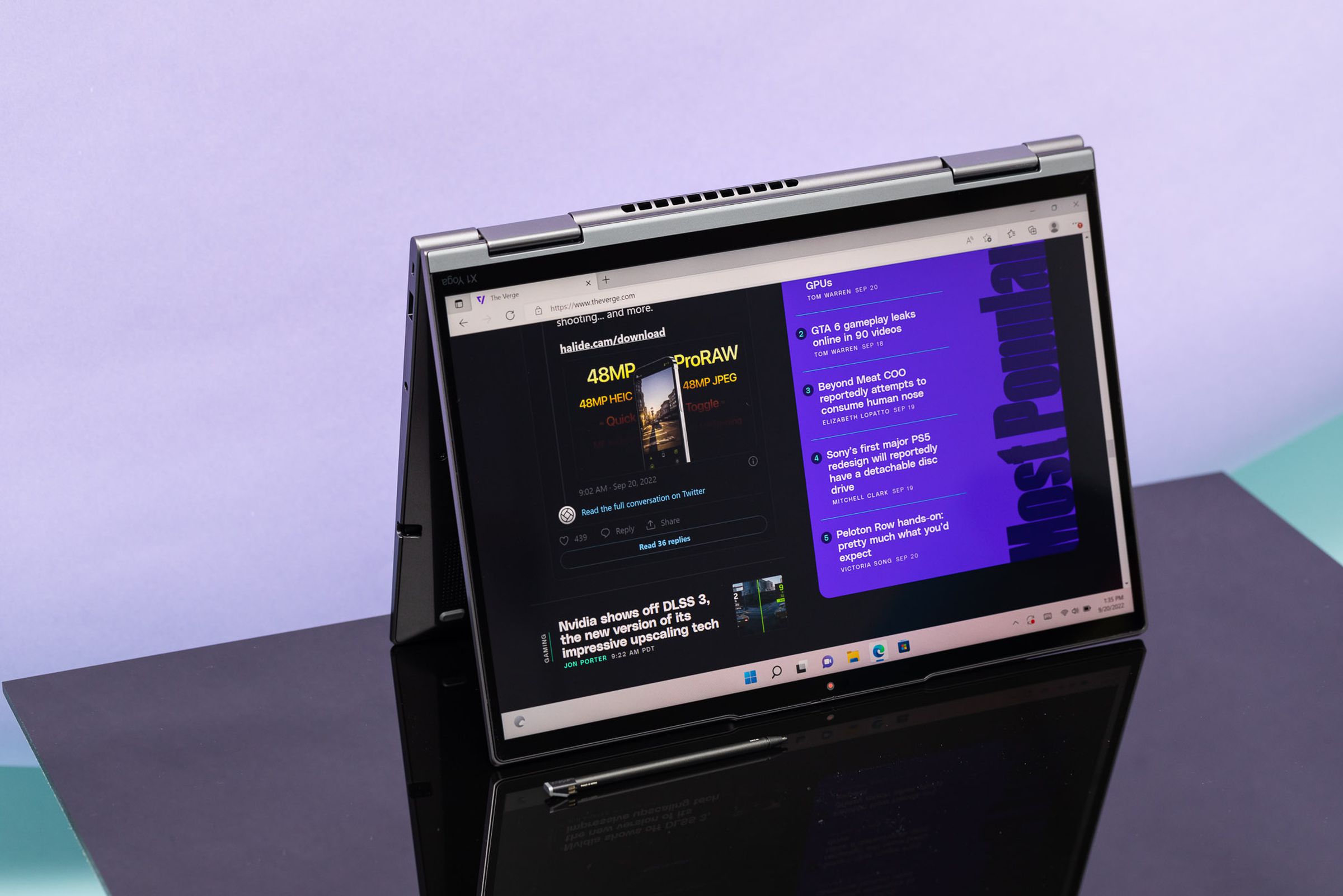 The Lenovo ThinkPad X1 Yoga Gen 7 in tablet mode displaying The Verge homepage.