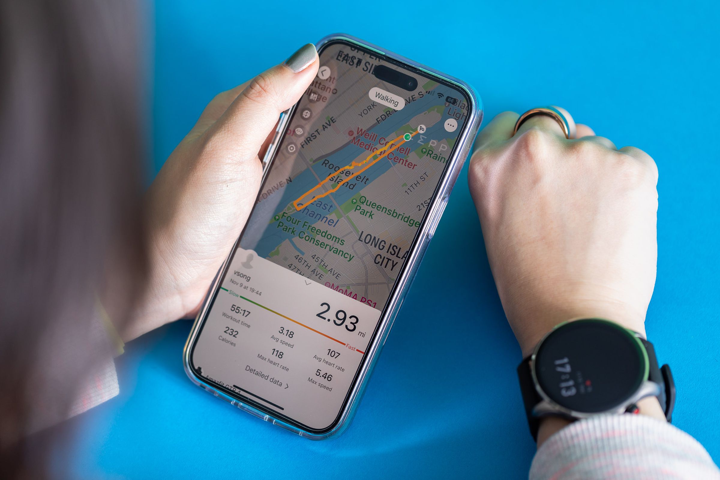 Woman viewing a walking activity summary on the iOS Zepp app while wearing the Amazfit GTR 4