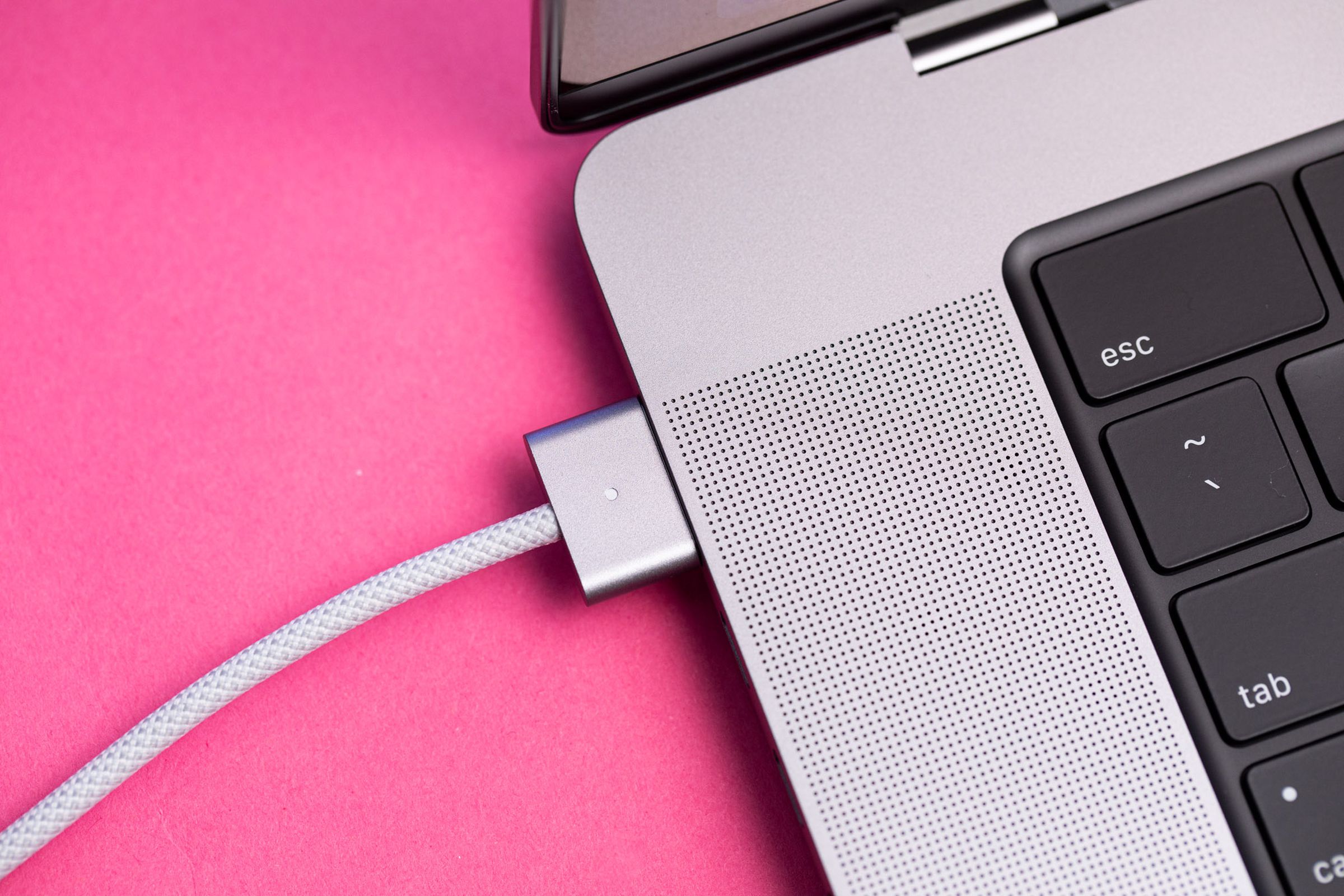 The MagSafe charger plugged into the MacBook Pro 16.