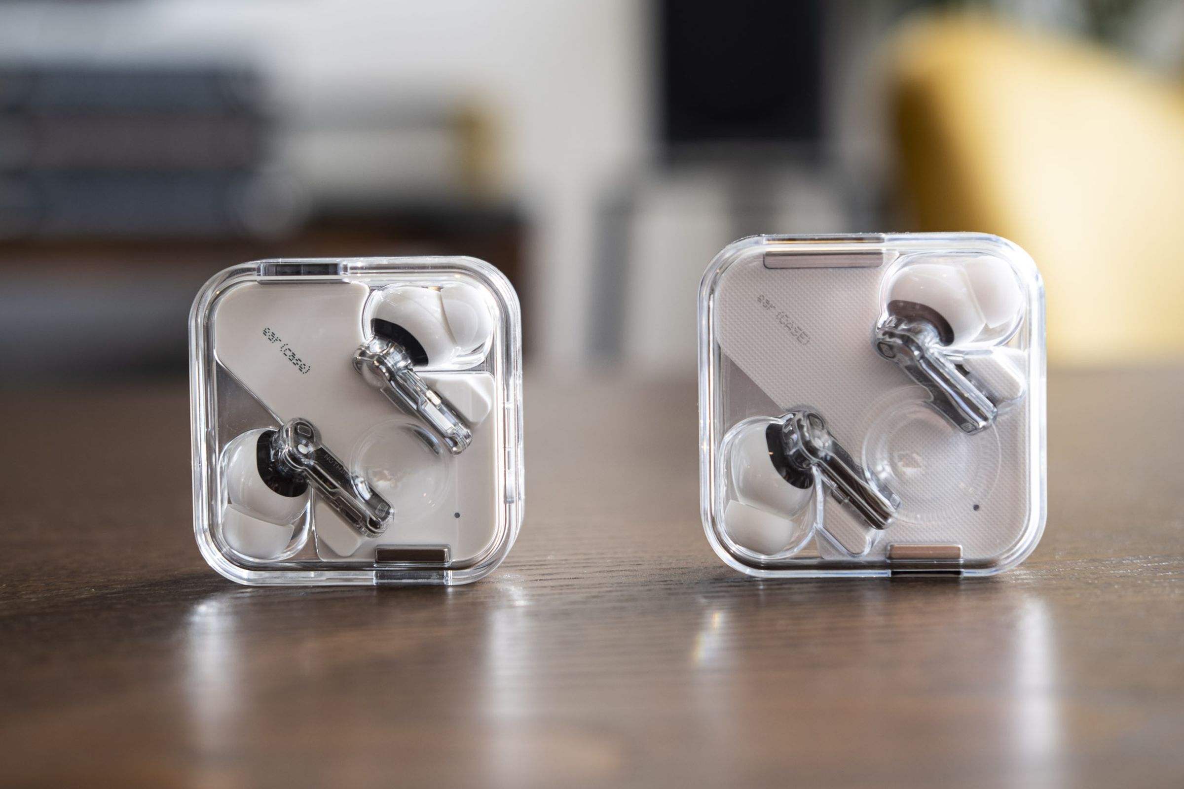 Ear 1 earbuds and Ear 2 earbuds in charging case.