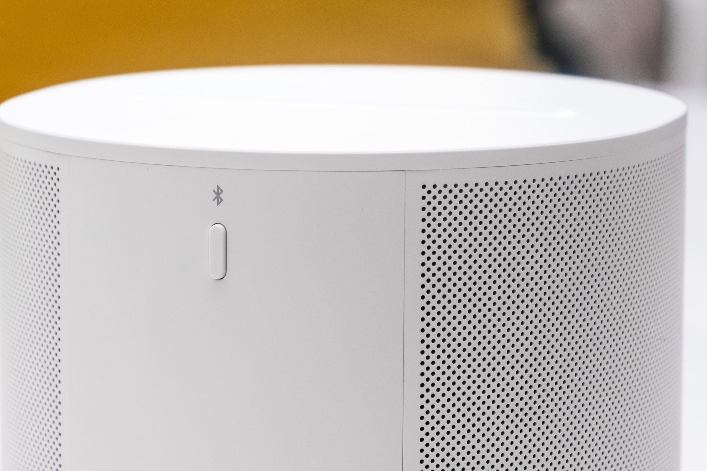 A close-up photo of the Bluetooth button on the Sonos Era 100.