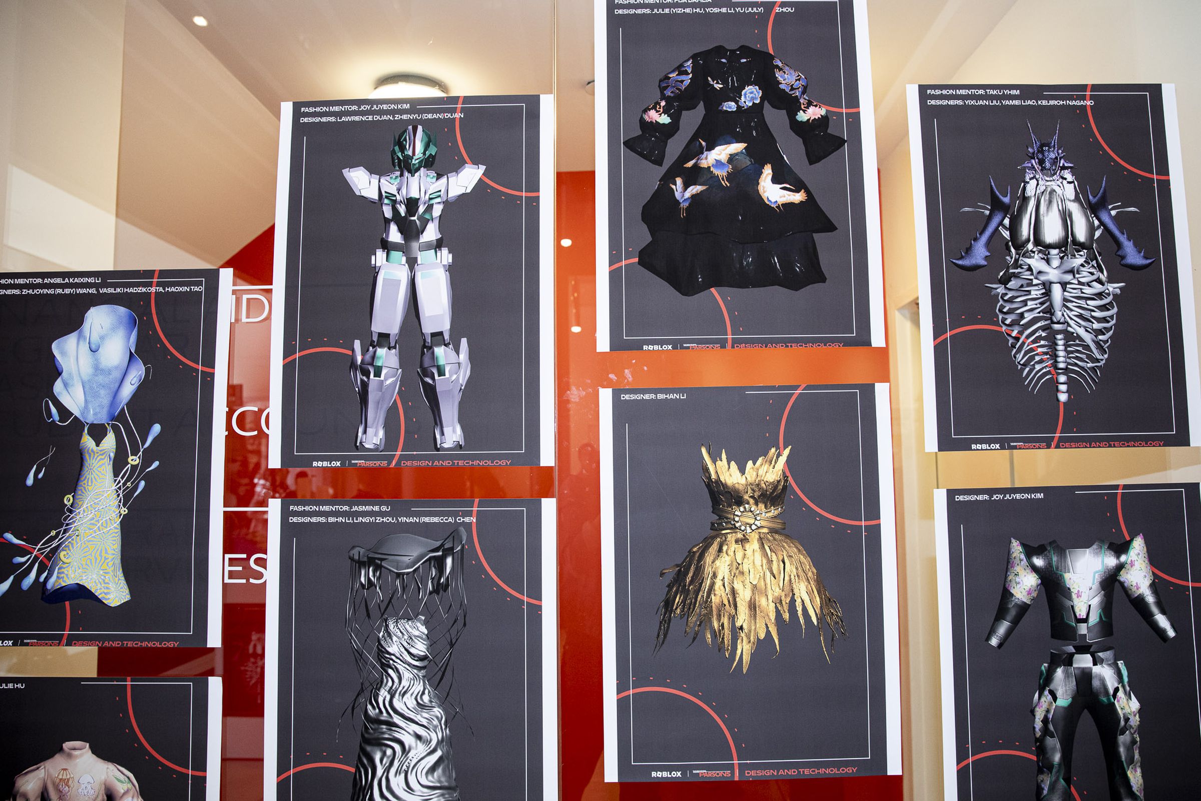 A collection of digital garments printed on to physical paper and hung on a wall.