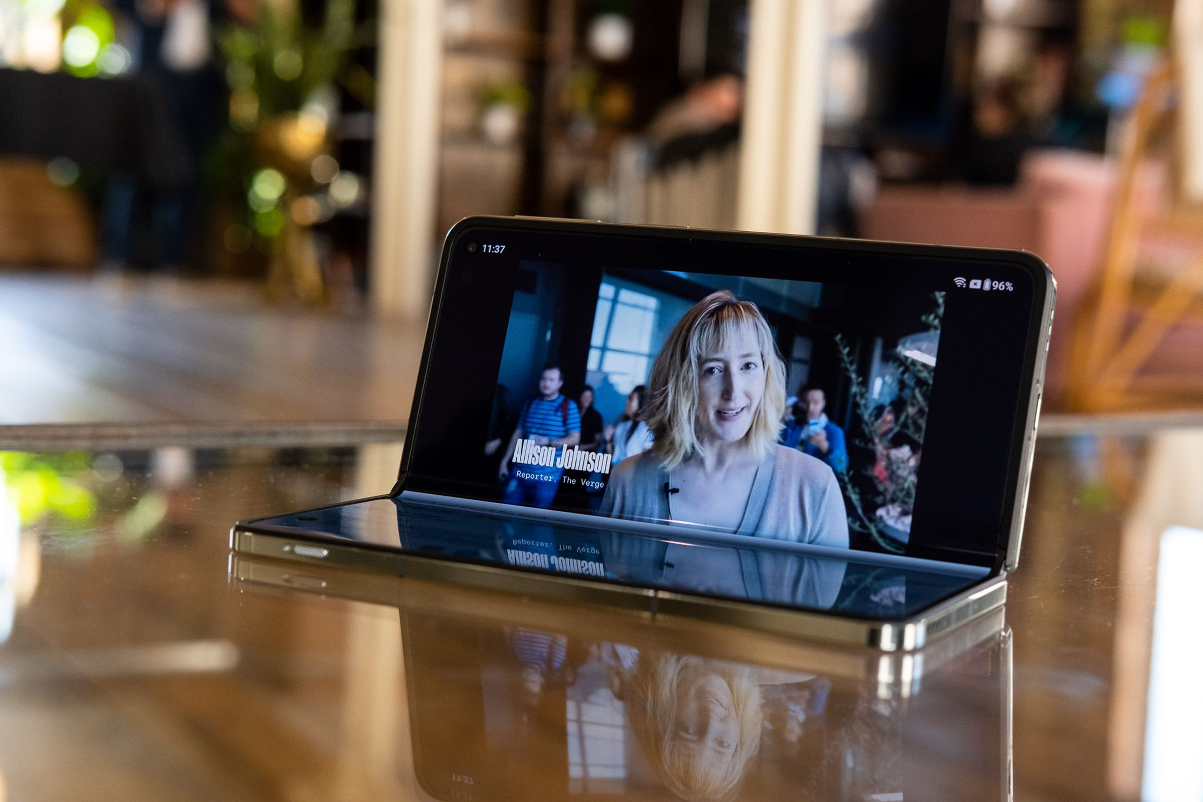 OnePlus Open half-opened on a table playing a youtube video.