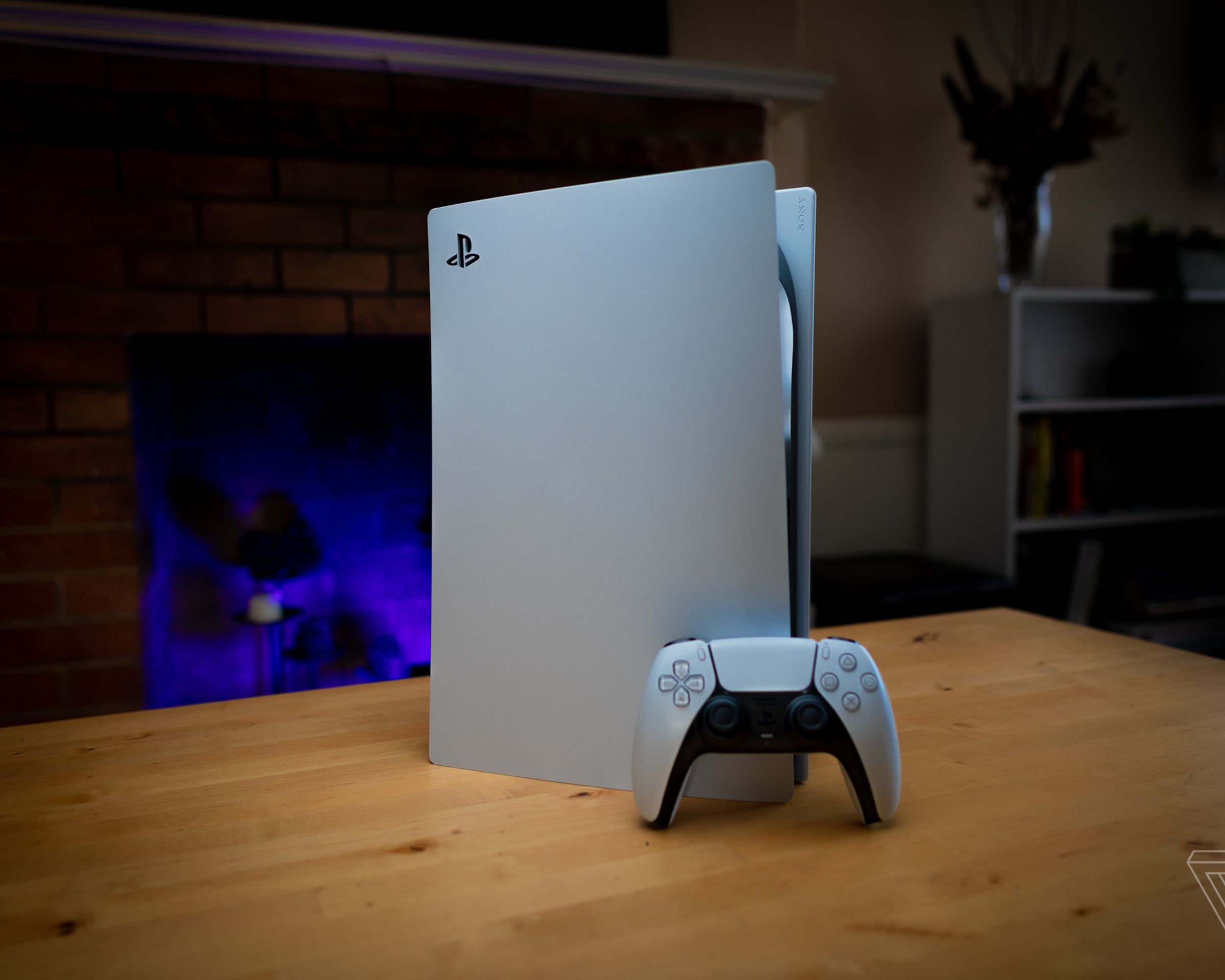 A PS5 console on a wooden table.